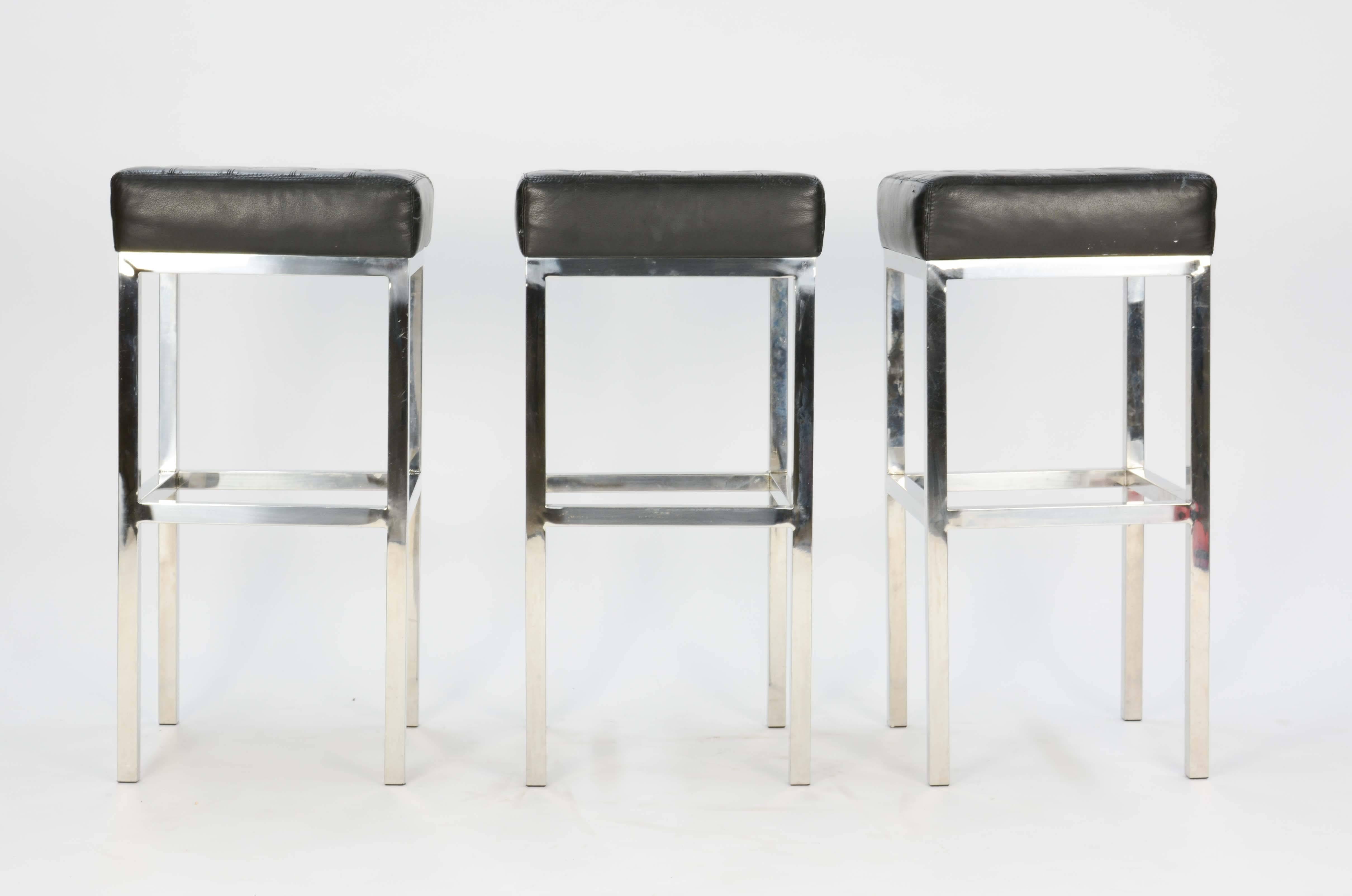 Excellent and comfortable bar or counter stools in the manner of Mies Van Der Rohe. They are sound and solid stools with the tuffed leather patterning of Mies' work for knoll.
