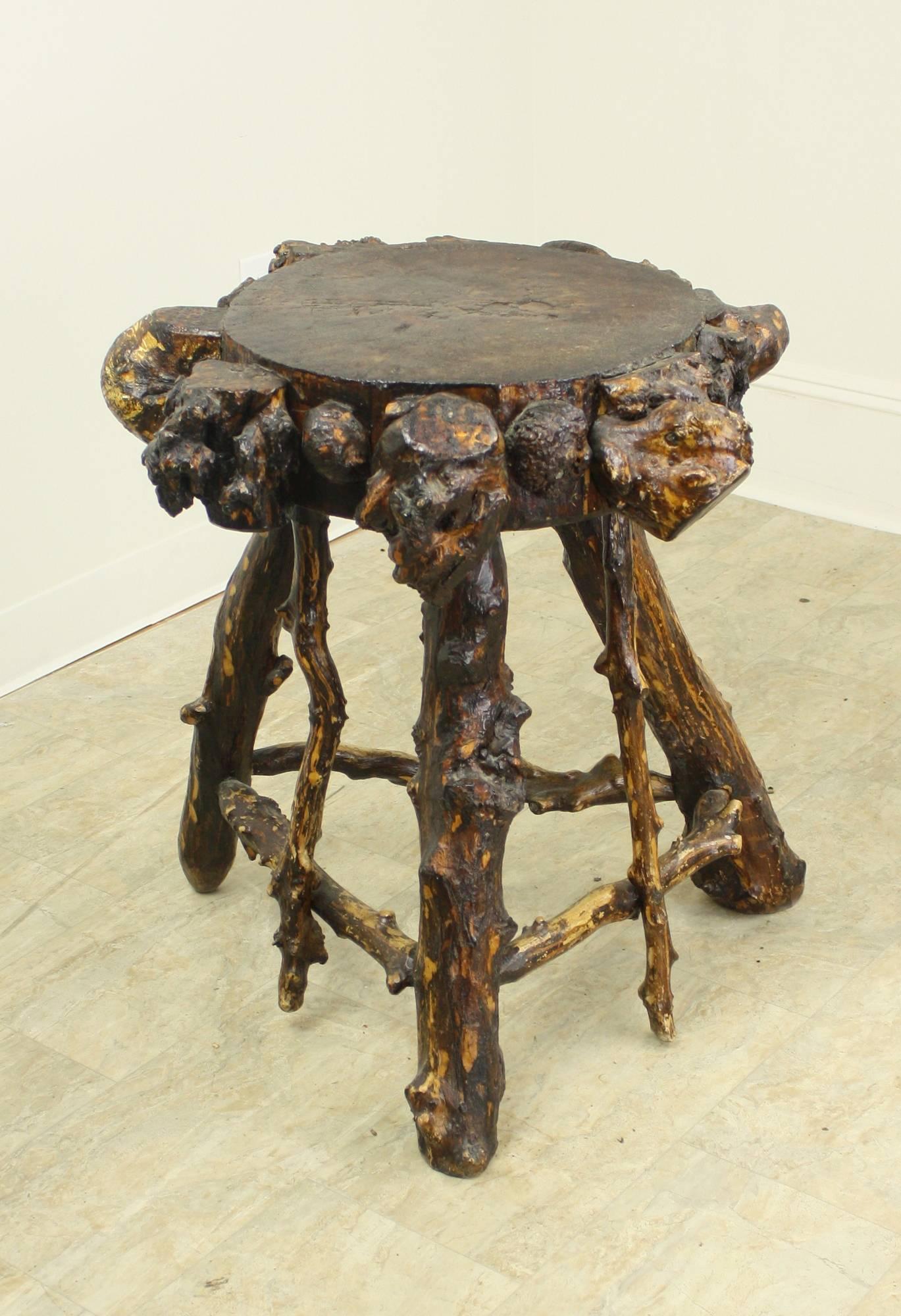 A terrific eye-catching table from Sweden and quite a conversation piece as well. This is a good height to put a drink on, and a nice size to sit next to an armchair. The burrs used to decorate the thick top are great. Heavy, solid and sturdy. Most