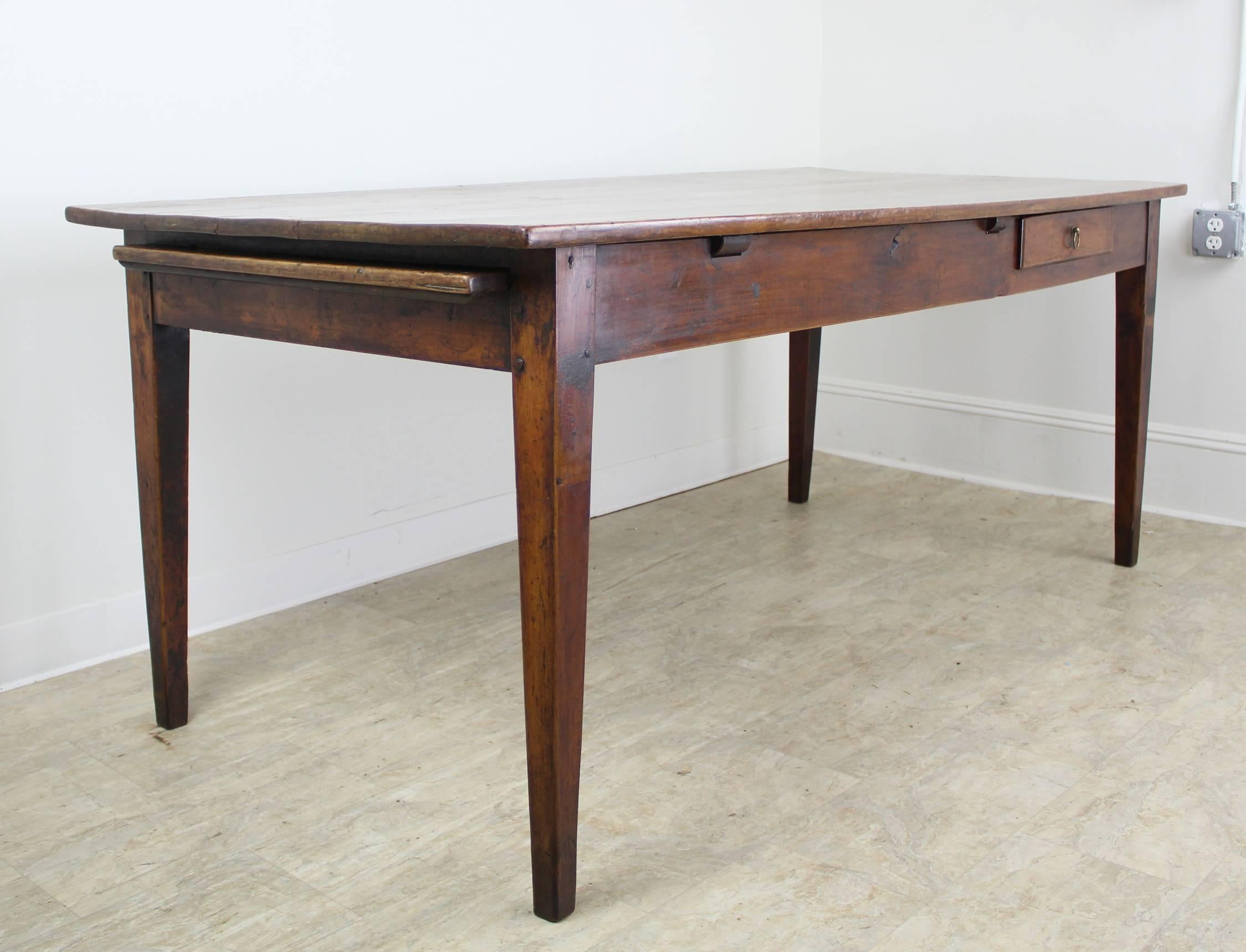 Offering the Classic elements of an exceptional antique French dining table. Standard length for eight with nice depth for plates on the side and platters down the middle. The table has lovely slender tapered legs, and the added visual interest of a