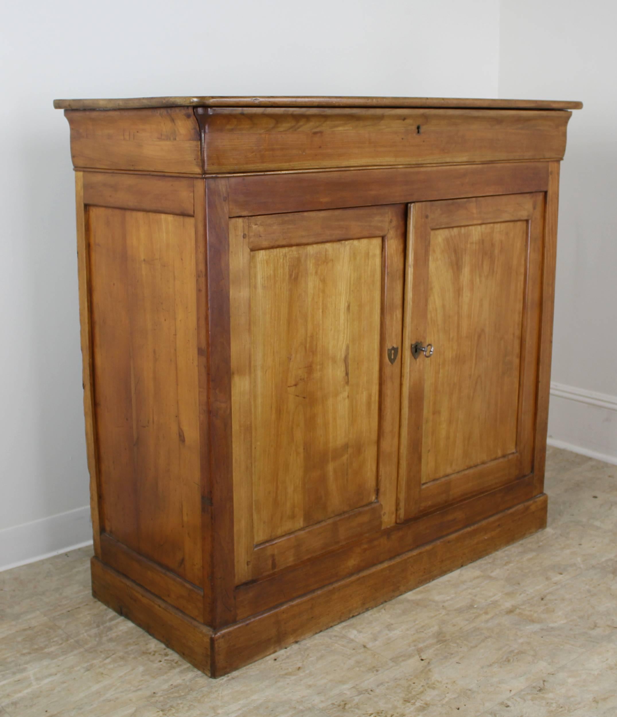 A taller buffet in warm cherry. This piece boasts classic features: nice baseboards at bottom, inset panels on the doors, and a hidden drawer in the crown molding. The two interior shelves provide excellent storage. We like the slimness of this