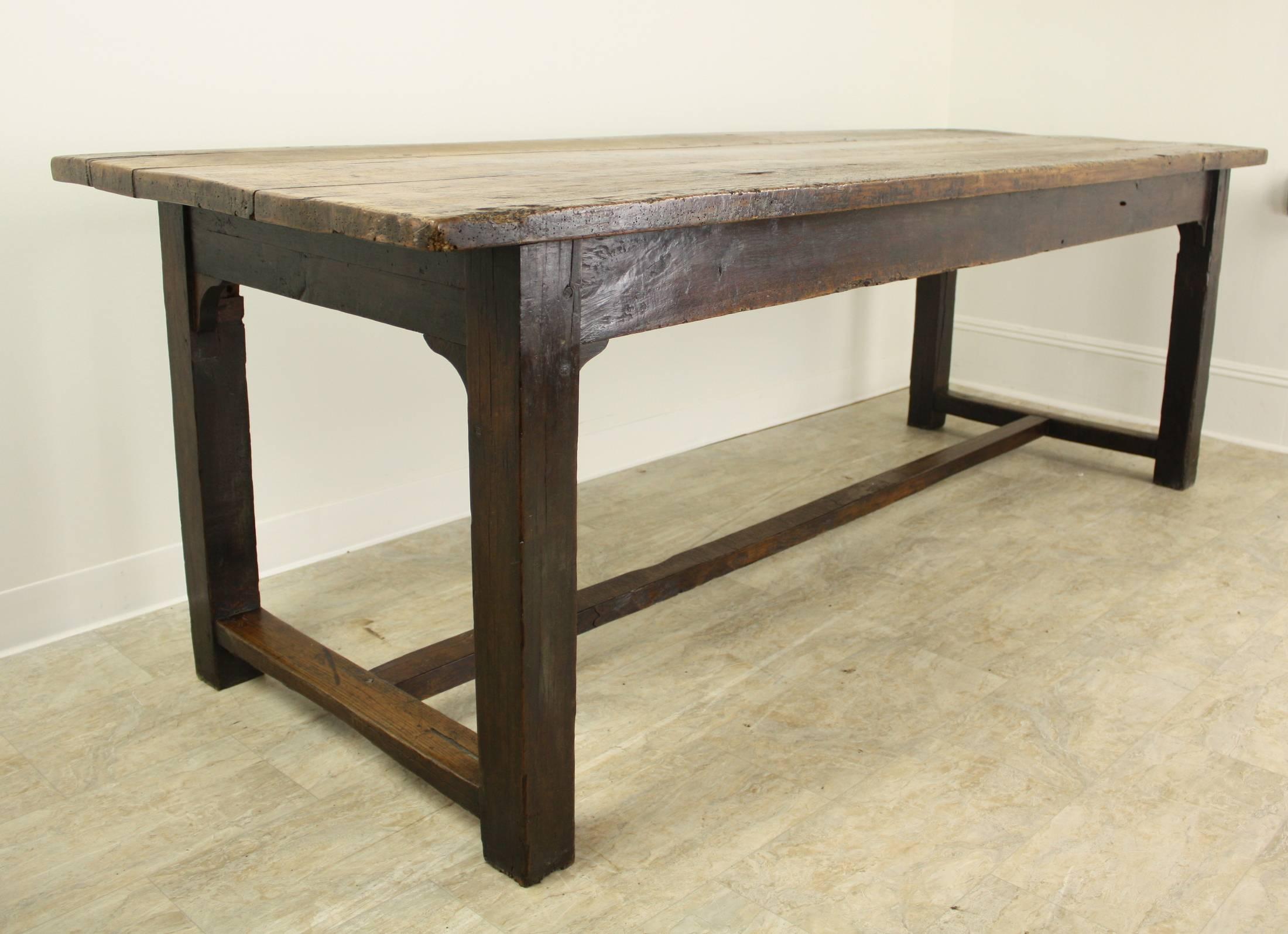 This table has a dramatic, very antique, look. It is a great, large, size.  Lovely distressed beechwood top has a beautiful patina, excellent grain. The oak stretchers are very attractive, tho do get in the way of pulling a chair under when one sits