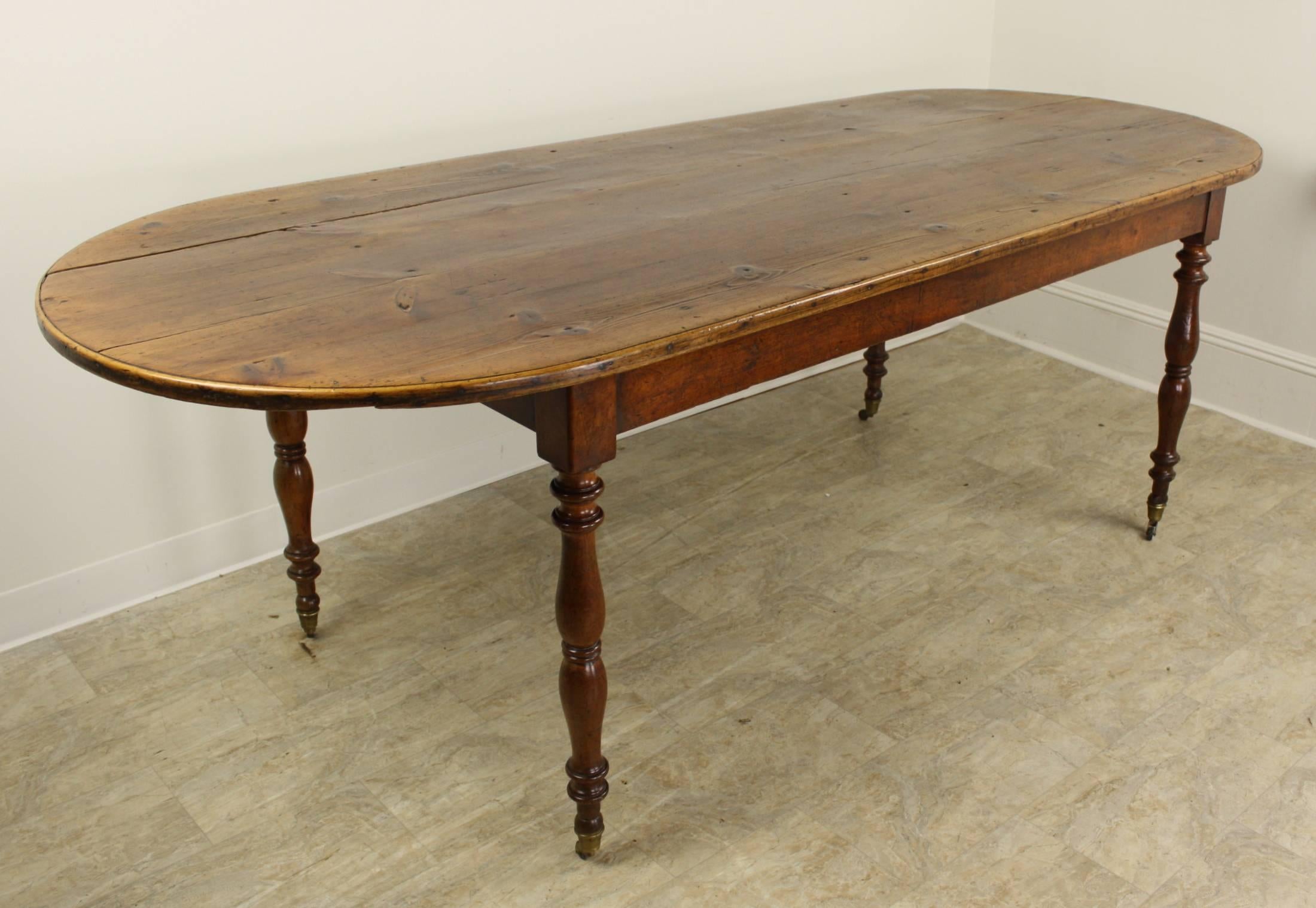 This is a good size, allowing seating for 12, with medium size chairs, this is a great dining table. Very pretty top as the color is a warm, cherry-like tone, very compatible with the rich cherry base. Attractive hand-turned legs end in original