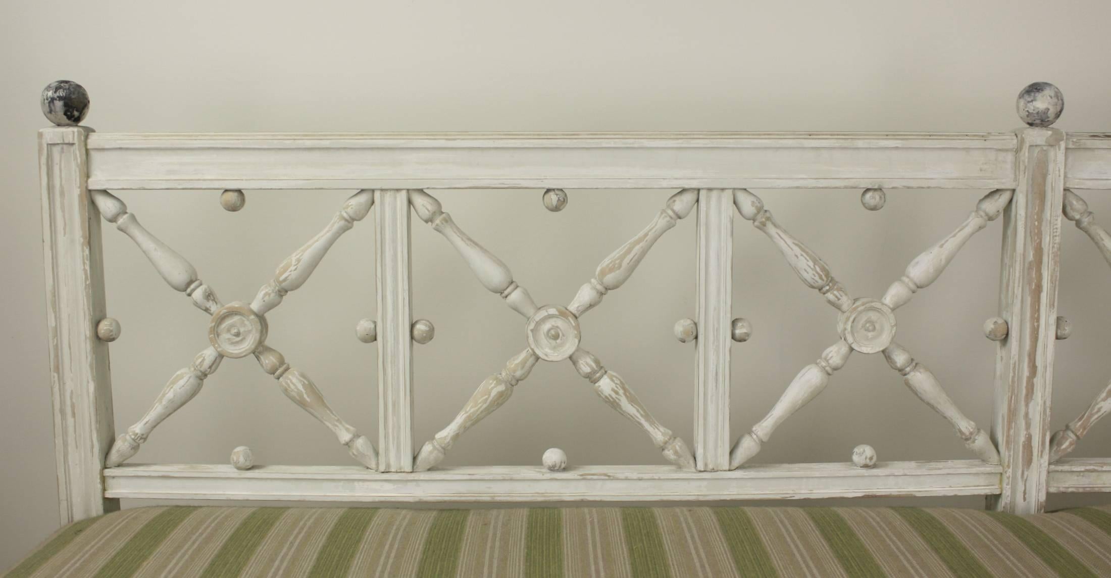 A stunning seven foot long Gustavian bench, very decorative with rubbed-back old paint. The 