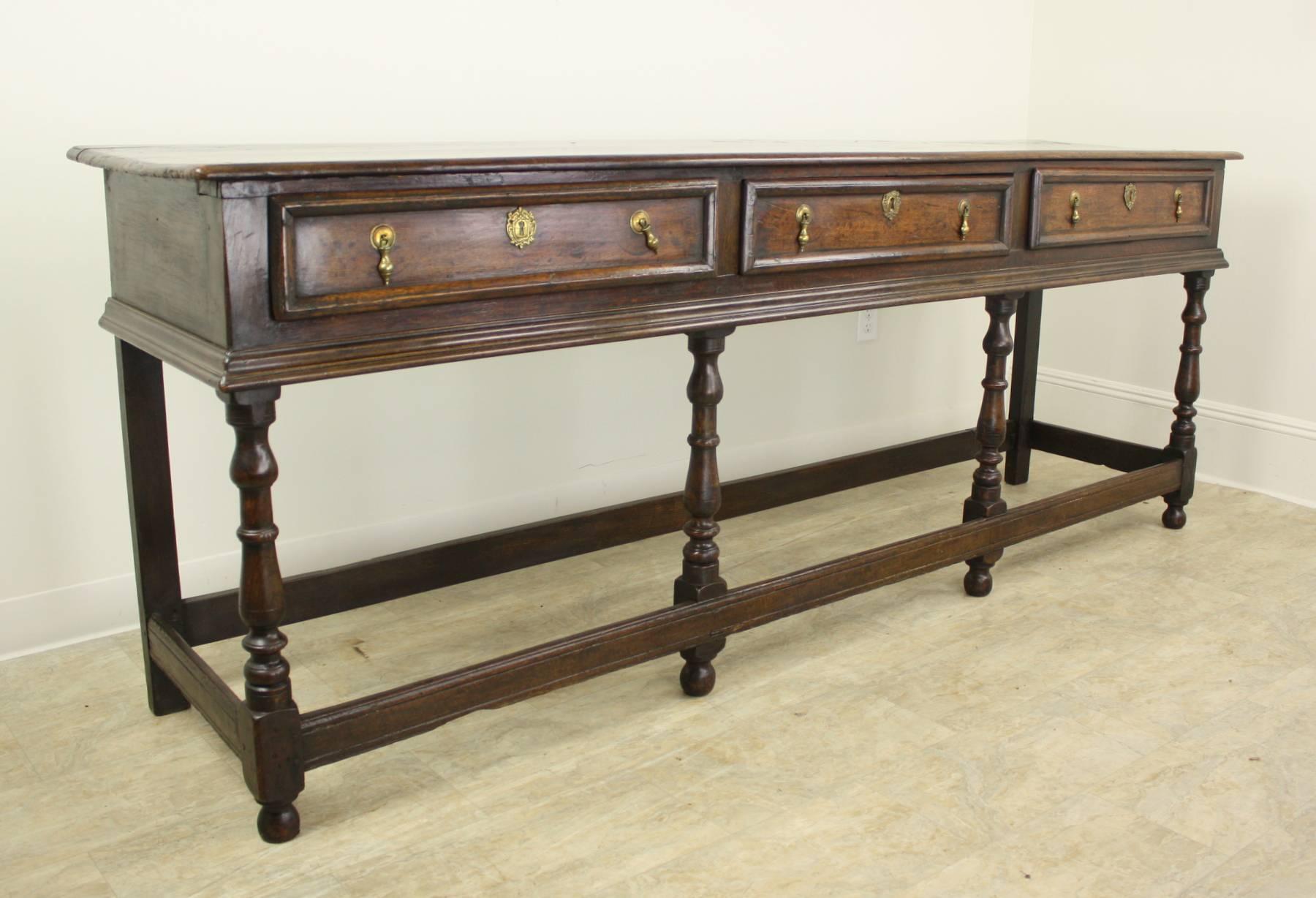 With fine strong moldings around the top and bottom of the drawer section, and fine moldings around the drawer fronts, this console is an excellent example of  classic early Welsh period furniture. The legs are wonderfully turned, and the all-around