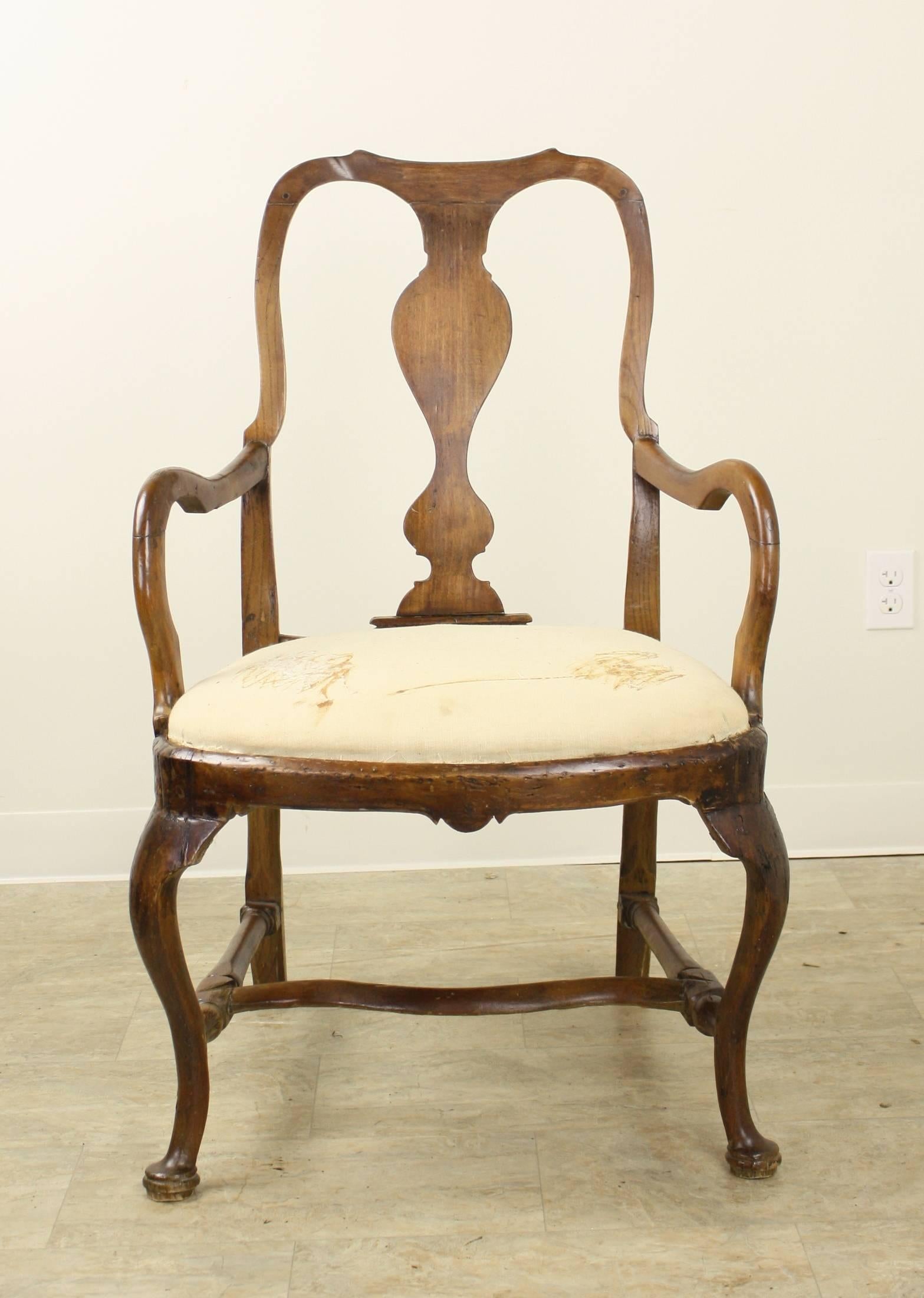 A glorious chair, it is perfection in its gracious and elegant lines. So clearly handmade, every line of this beautiful profile is gentle yet strong and beautifully shaped. The rich color and patina are exemplary and the fine base with the shaped
