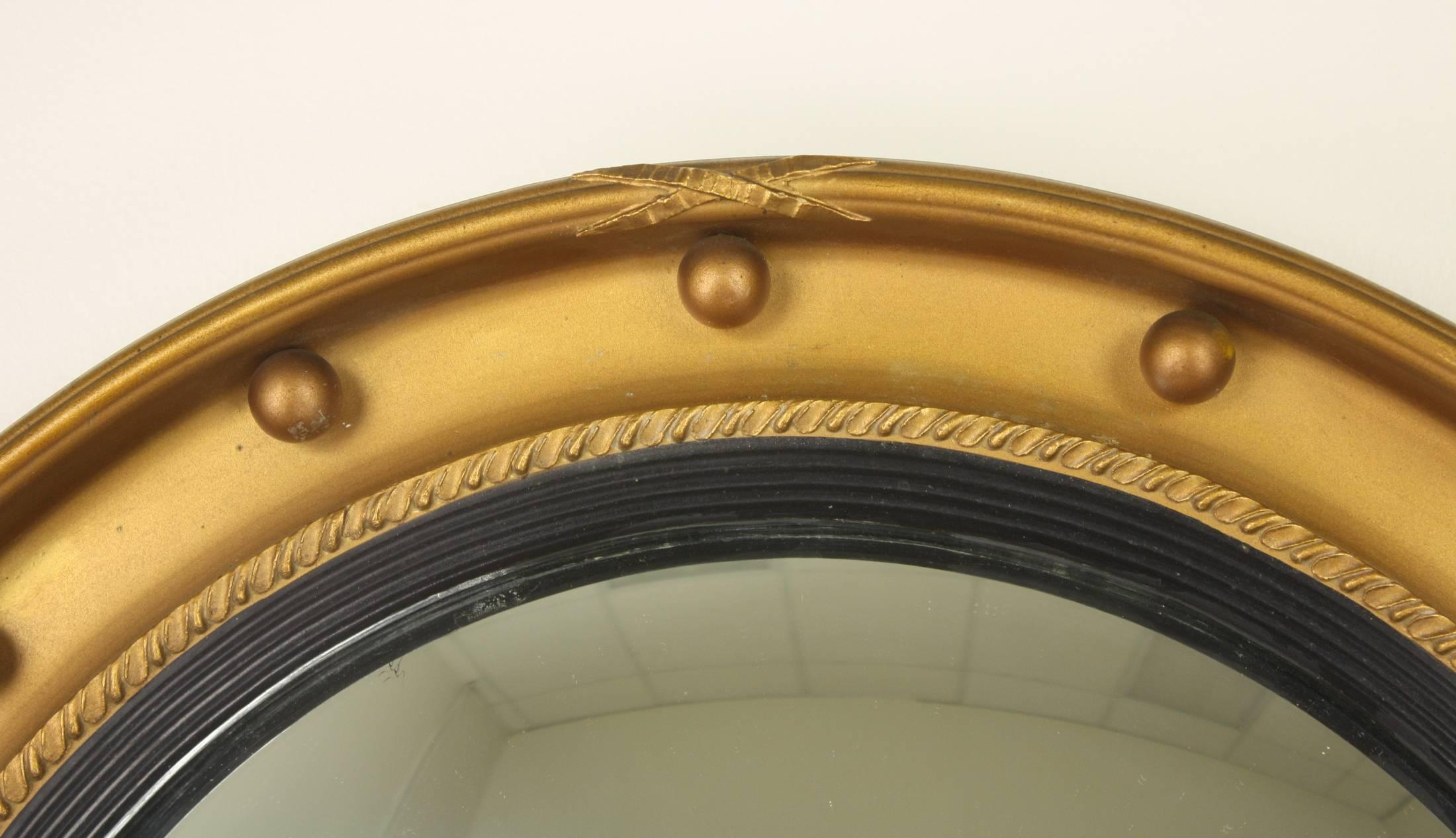 A 19th century wood and gesso frame, with a ribbed and ebonized inner band. The gilt finish is in very good antique condition, and the original glass is also, with small areas of spotting around the edge. A glamorous look!