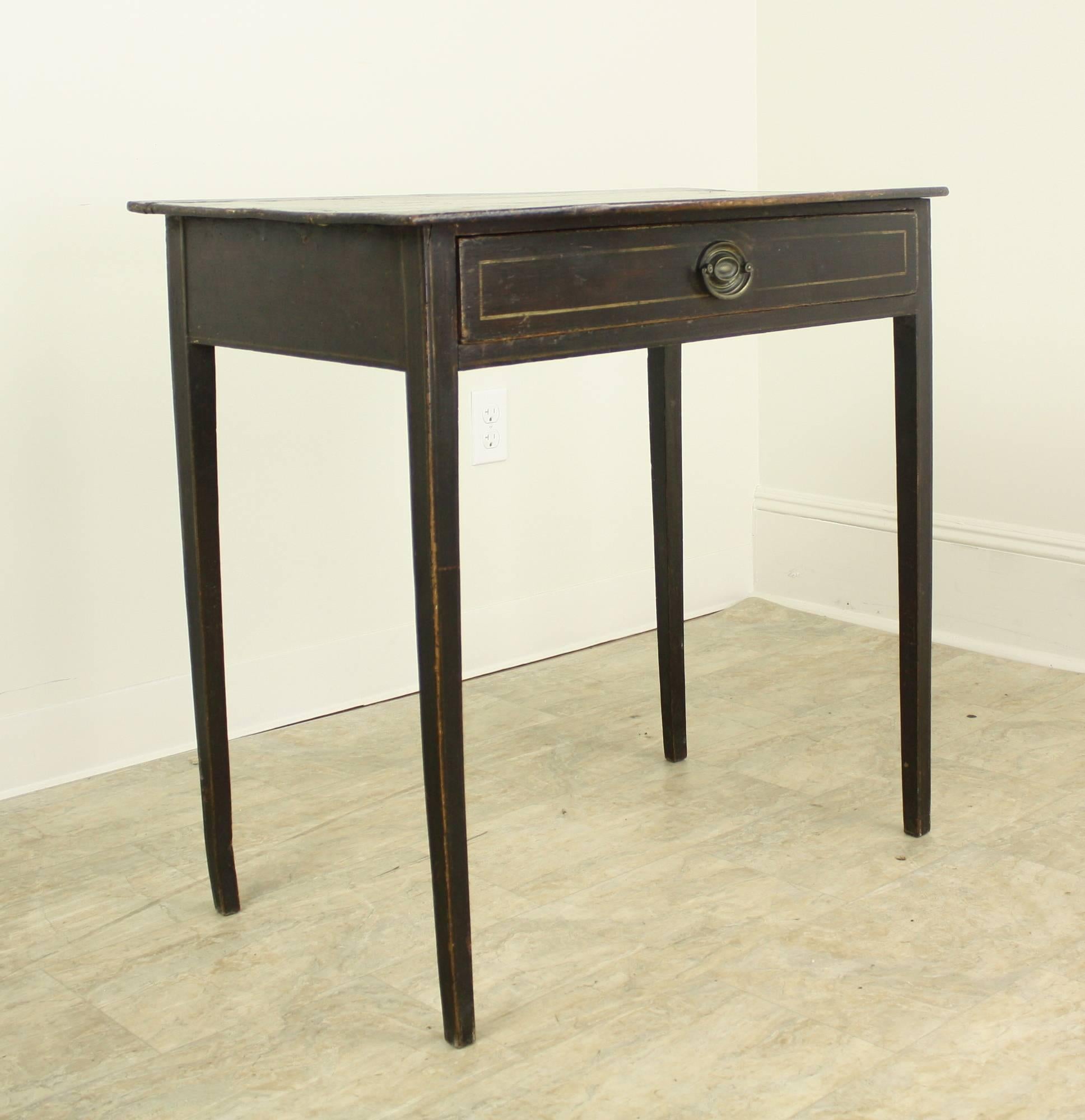 A graceful Regency side table in fabulous distressed condition. Bowed top adds interest as does the original decorative paint. Tapered legs complete the look.