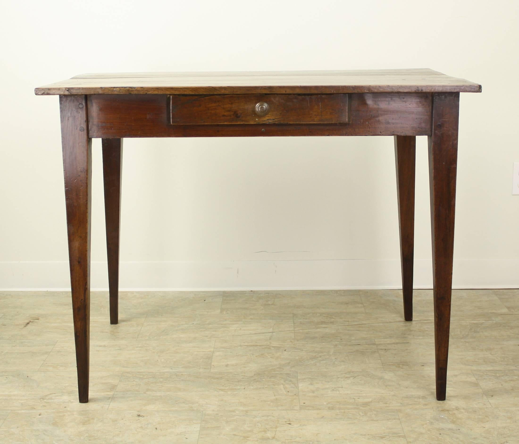 A pretty writing table, desk or side table with wonderful grain and patina. The thin elegant legs and single centre drawer complete the look. Apron height of 25.5