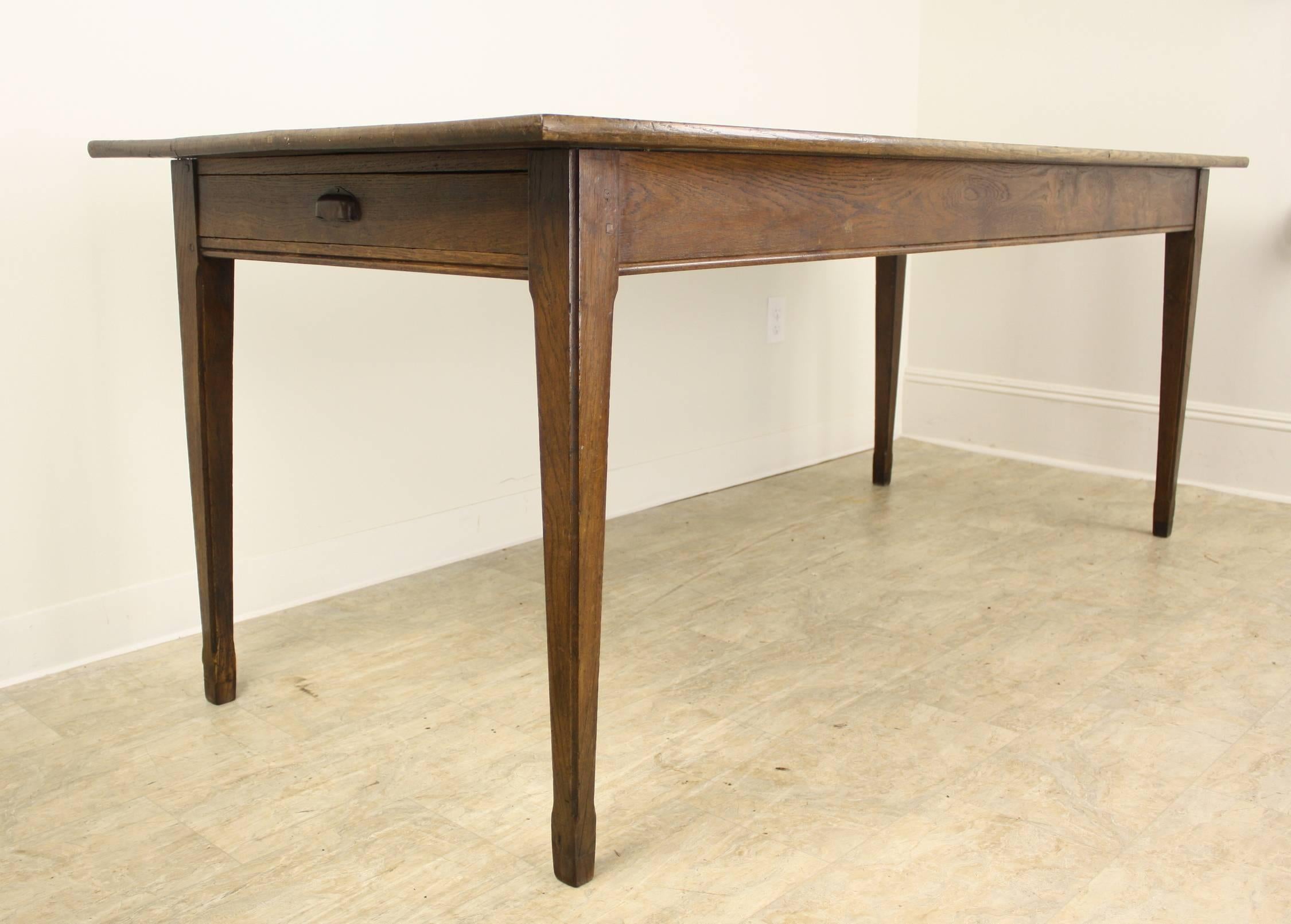 A nicely proportioned oak farm table, with routed details on the legs and apron. Very good grain, color and patina. 24.75