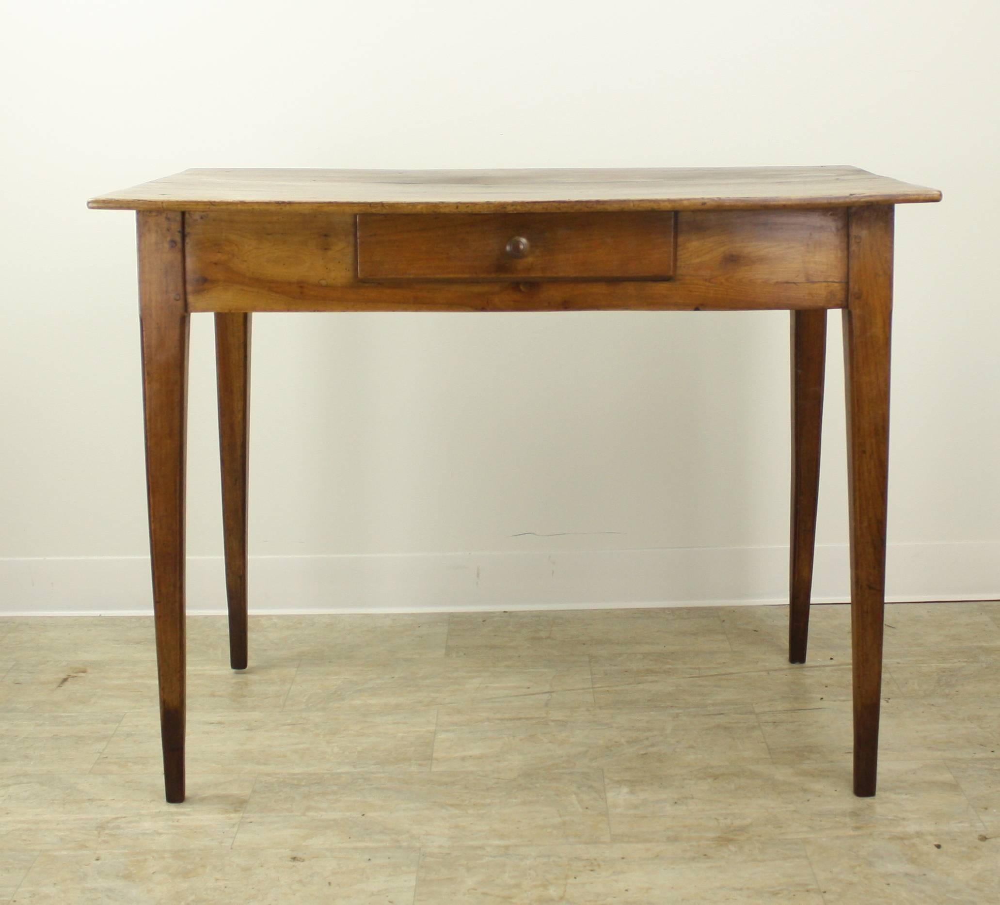 A very nice desk, over 3 feet in width, standard height, with an excellent apron height very comfortable at 25". Great walnut grain and color, with some interesting old distress on the top. Lovely French tapered legs, one small drawer in the