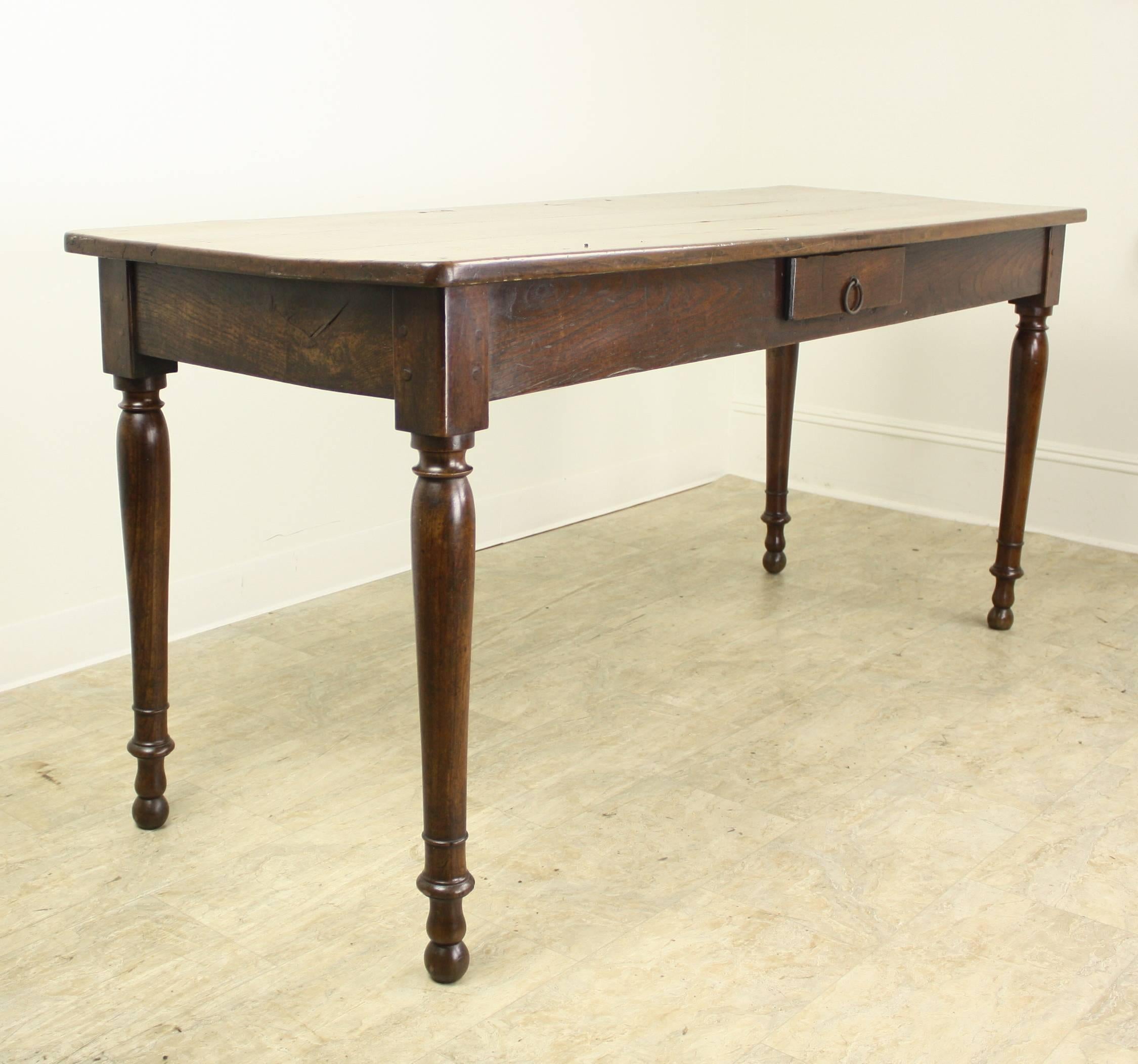 Quite a handsome piece in a lovely warm cherry tone, with graceful turned legs. Tho somewhat deep for a server at 24", it is very workable at that width. The piece could also work well as a narrow farm table, as it has an acceptable apron