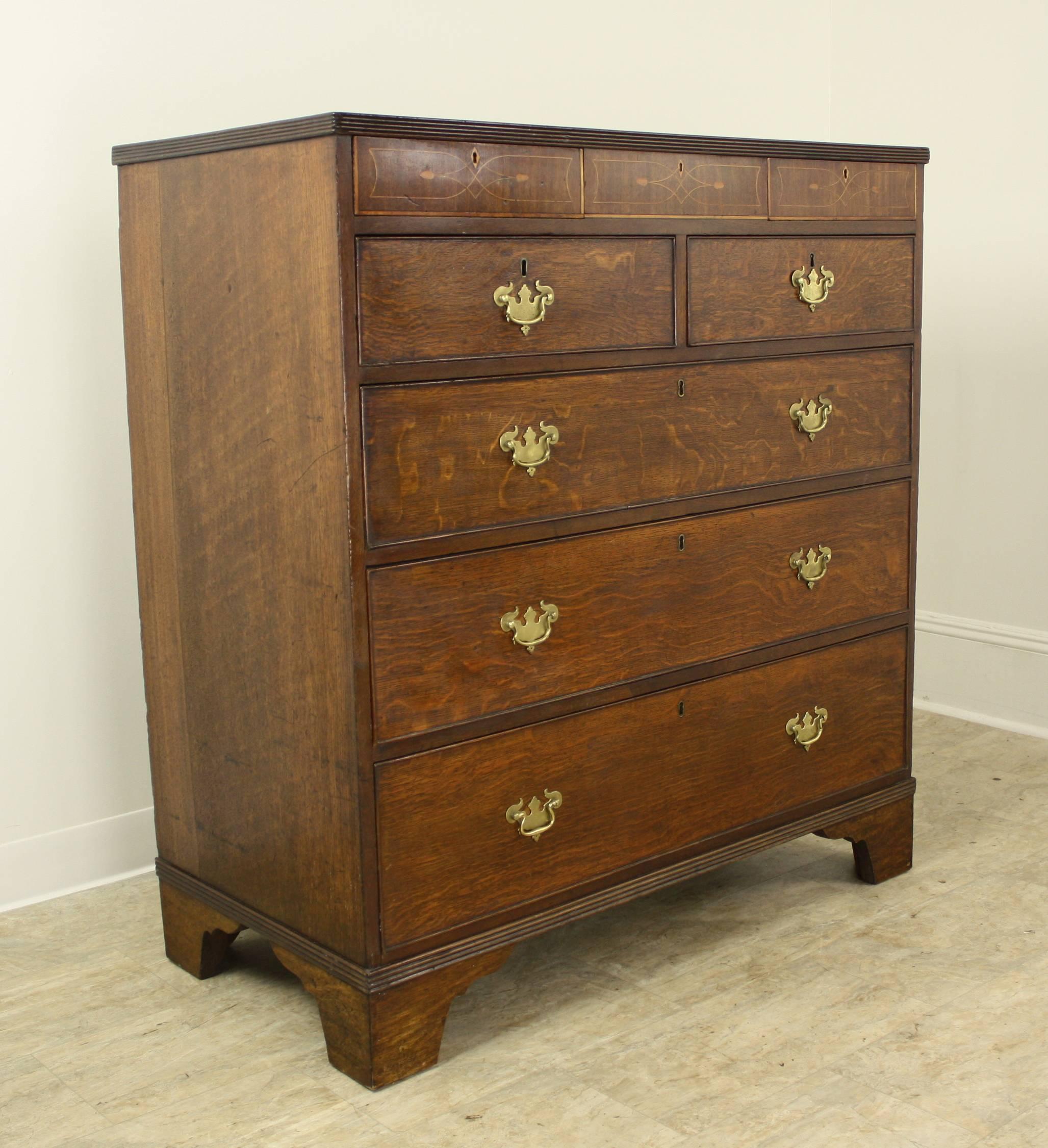 This bureau is a very fine, very early example of a classic English chest, but it has an added magical inlay pattern on the frieze. Please look at the fourth thumbnail for a close-up of an amazing work of marquetry, done in a formal, yet whimsical