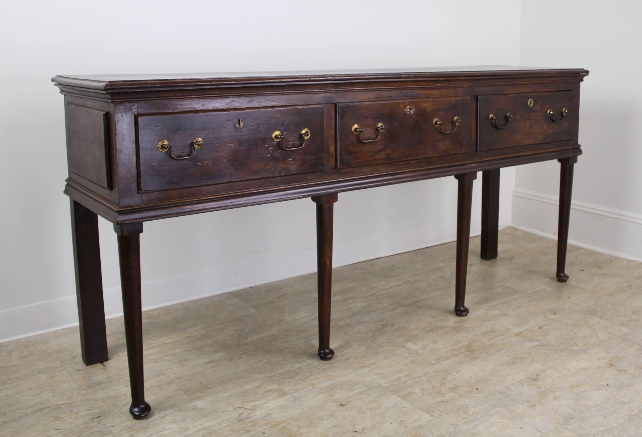 A rich dark oak server offering all the Classic very early components of the period. Great size for a variety of places in the home, in keeping with the farm table look. This excellent console would be lovely in an entry hall, setting the tone for a
