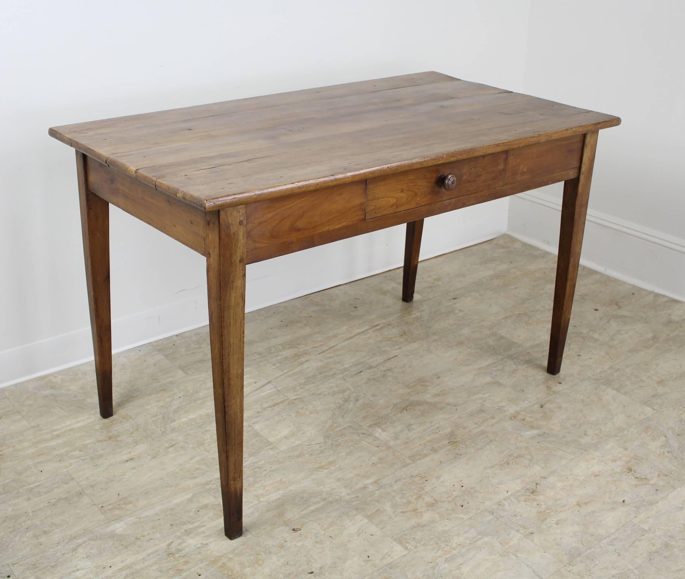 A splendid writing table in the warmest cherry with lovely grain and patina. The thin elegant legs and single centre drawer complete the look. Lovely little hand-turned knob. Apron height of 24 inches is very comfortable. Leg height was extended,