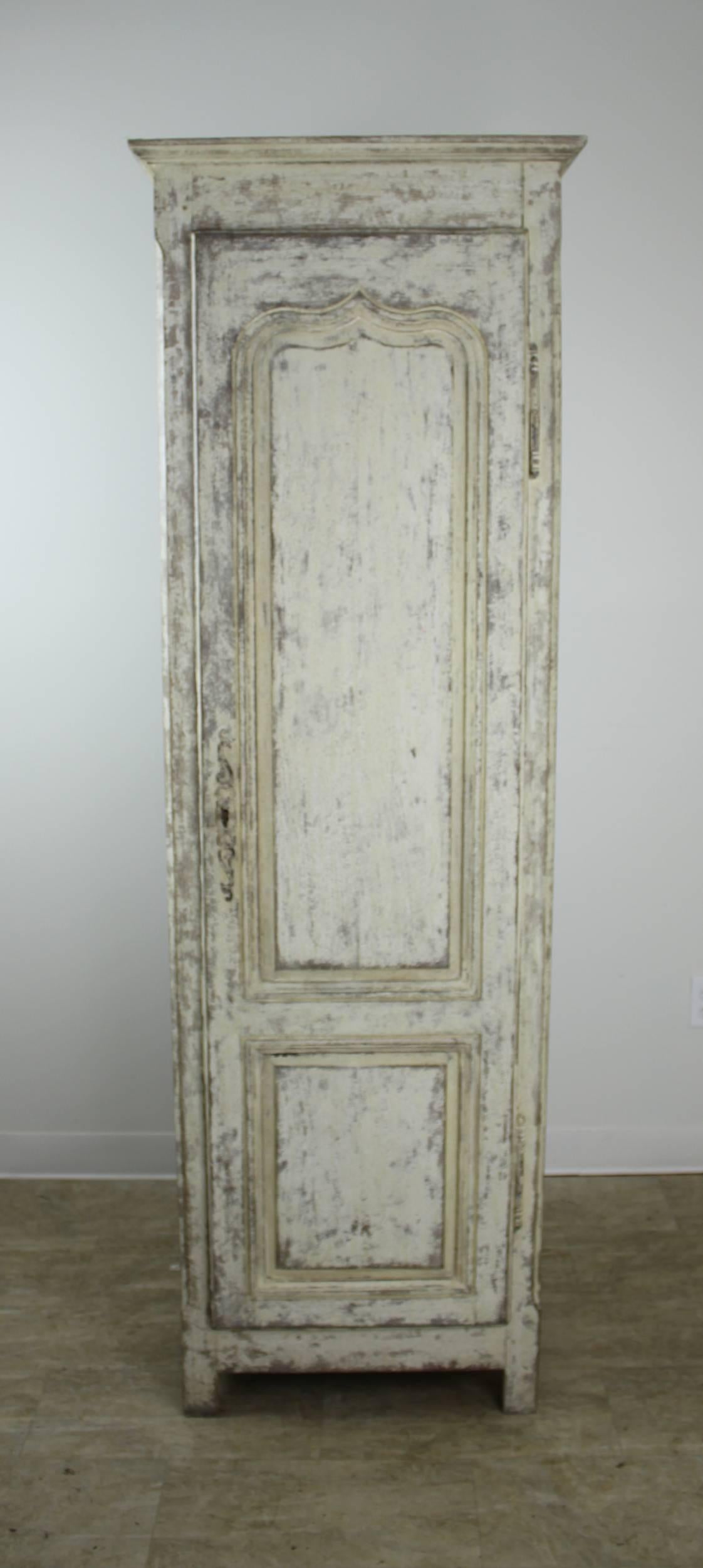A tall narrow French chimney cupboard, newly painted on the inside and enhanced on the outside. Four roomy interior shelves and a charming drawer that slides easily. Elegant crown molding and stylized inset door panel complete the look. Just right