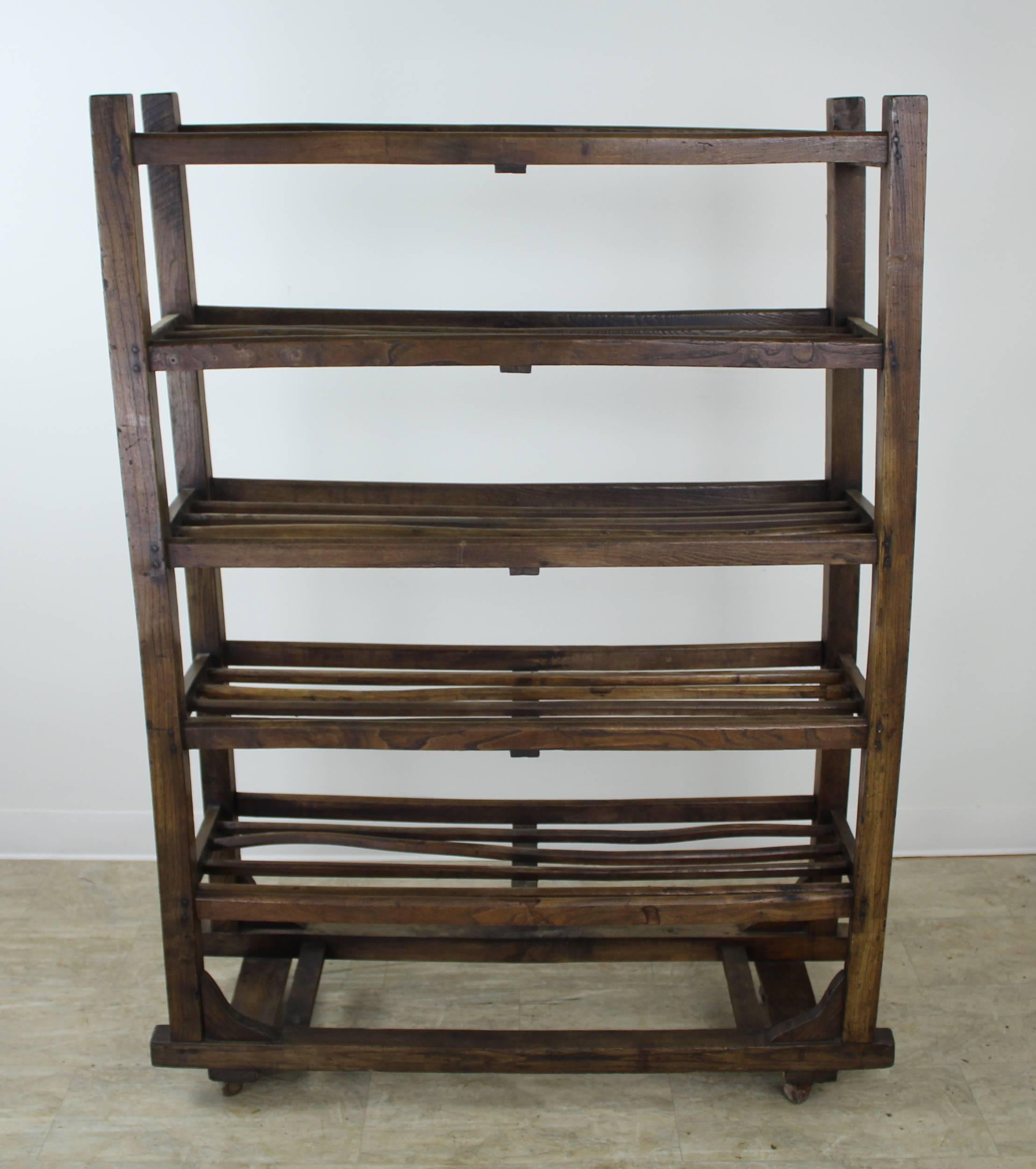 A beautiful elm apple rack, with endless possibilities. This piece boasts all of the desirable qualities of the best wooden antiques. Great color and patina, with its nice elm grain fully on display (see image #7). The slats on each shelf are hand
