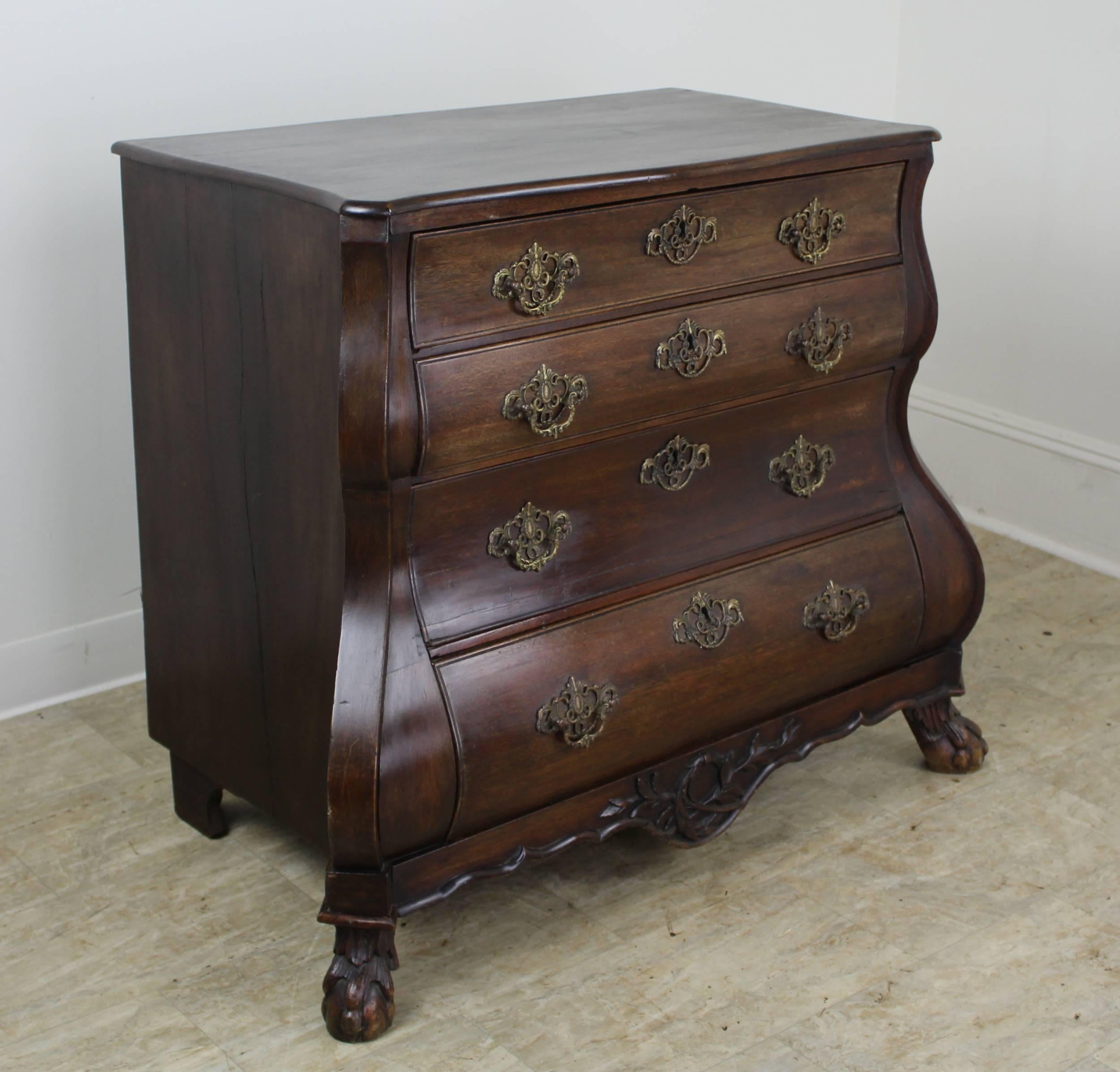 Fabulous early Dutch bombe chest, grand in presence. This four drawer bureau is made of dark oak with a beautiful color and rich patina. Details of note include all original handles, shaped and decoratively carved apron on the front, and gently