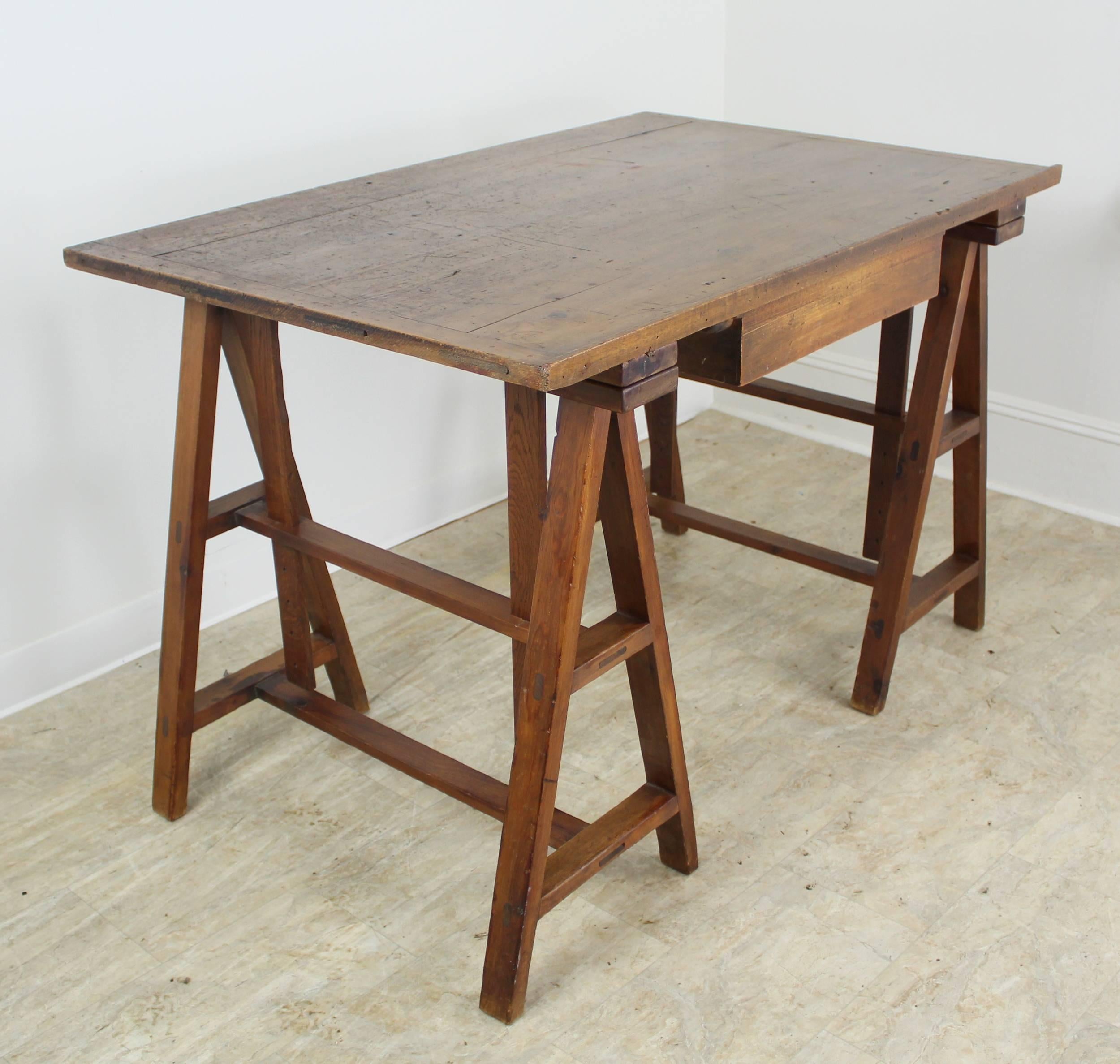 An antique pine architect's table from late 19th century, France, fully adjustable. The simple mechanism relies on four easily movable metal pegs that can change the incline of the table from flat to angled for drafting and other work. Nicely