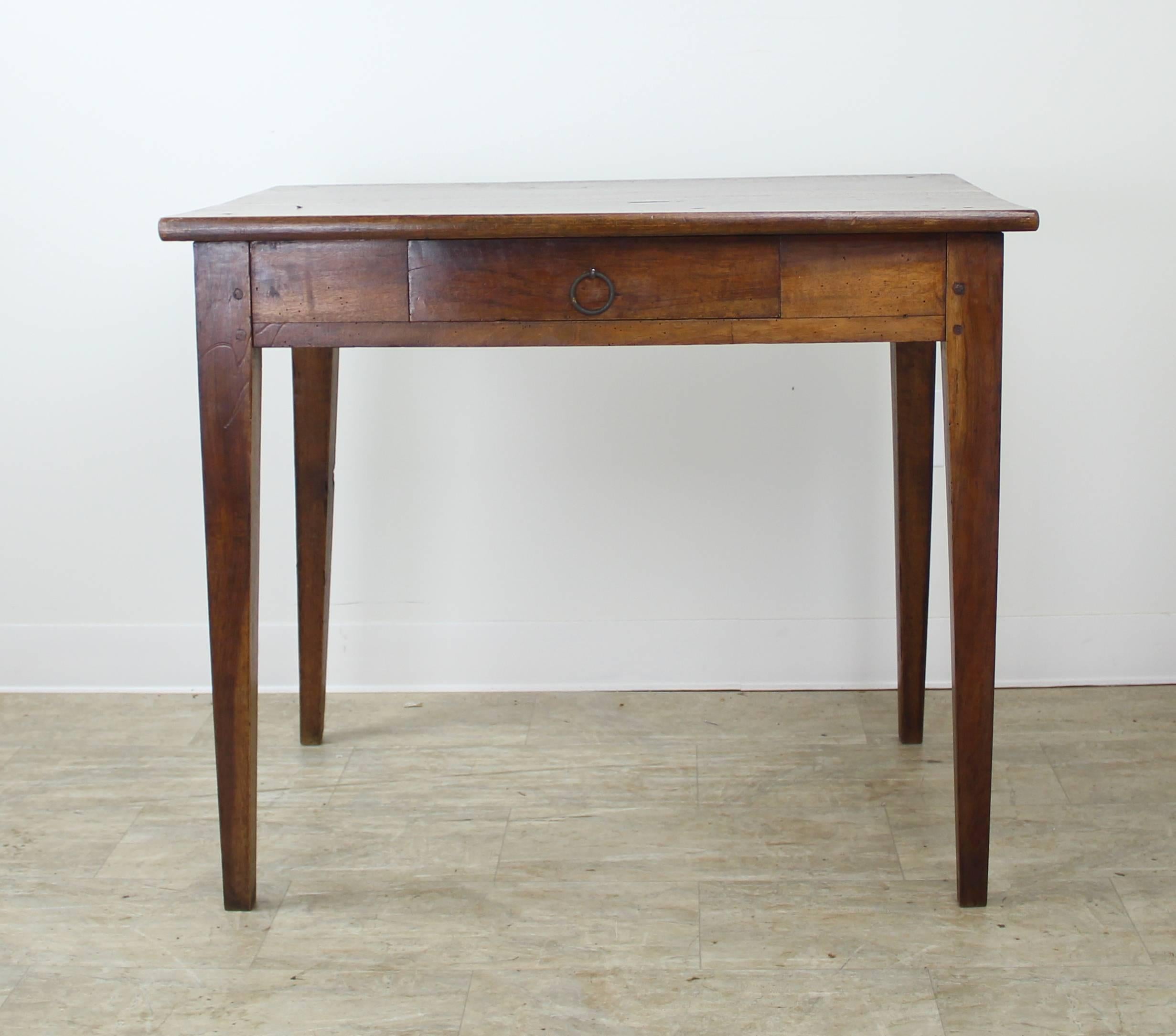 A charming side table, terrific walnut grain, this table is also a good height for a nightstand or a lamp table. One small drawer and lovely tapered legs.