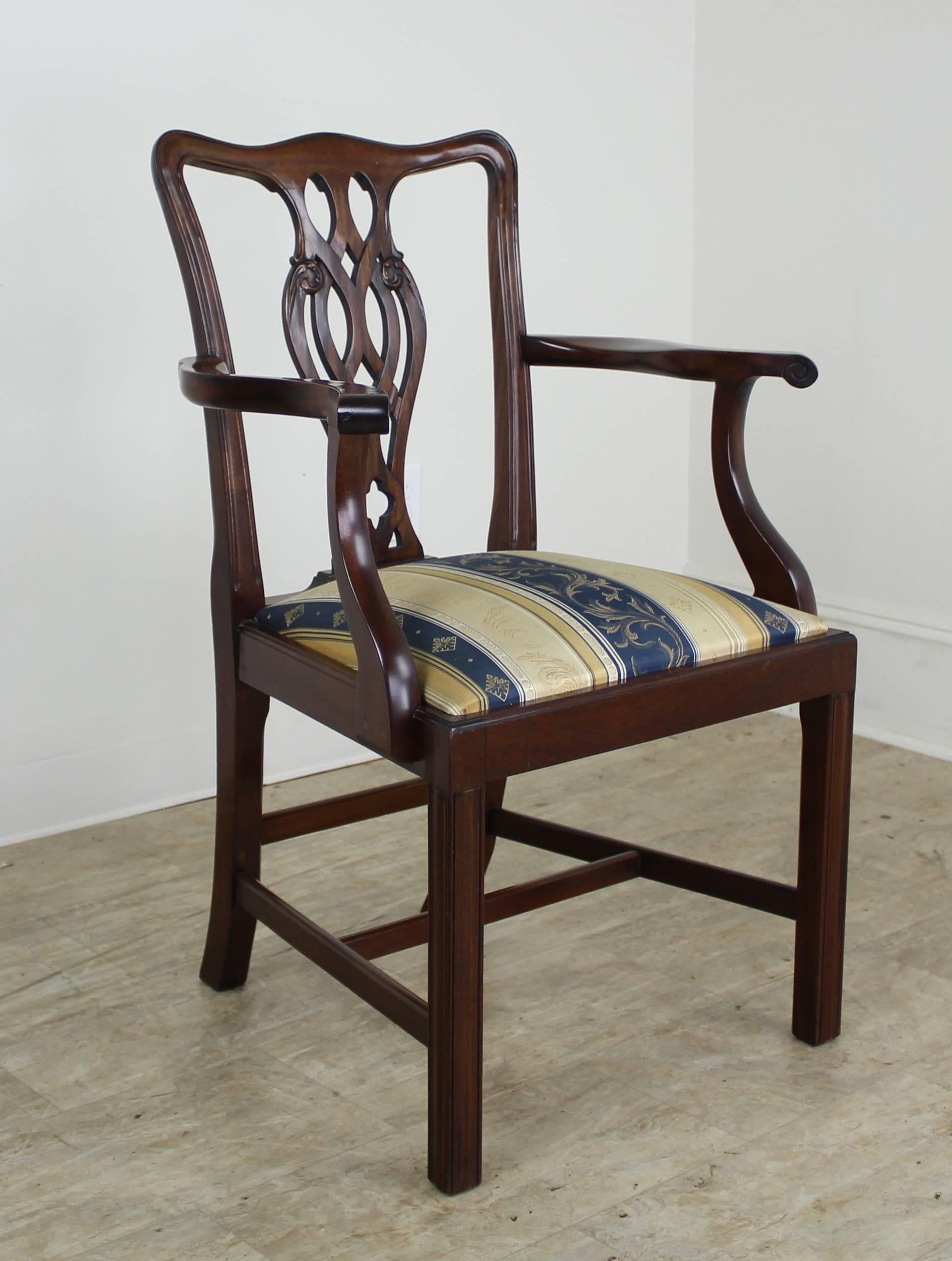 A full set of very handsome fine Chippendale style chairs. Two arms and six sides. The chairs are in a beautiful mahogany with exceptional color and a rich patina. There is some color variation due to light exposure over the years, but all chairs