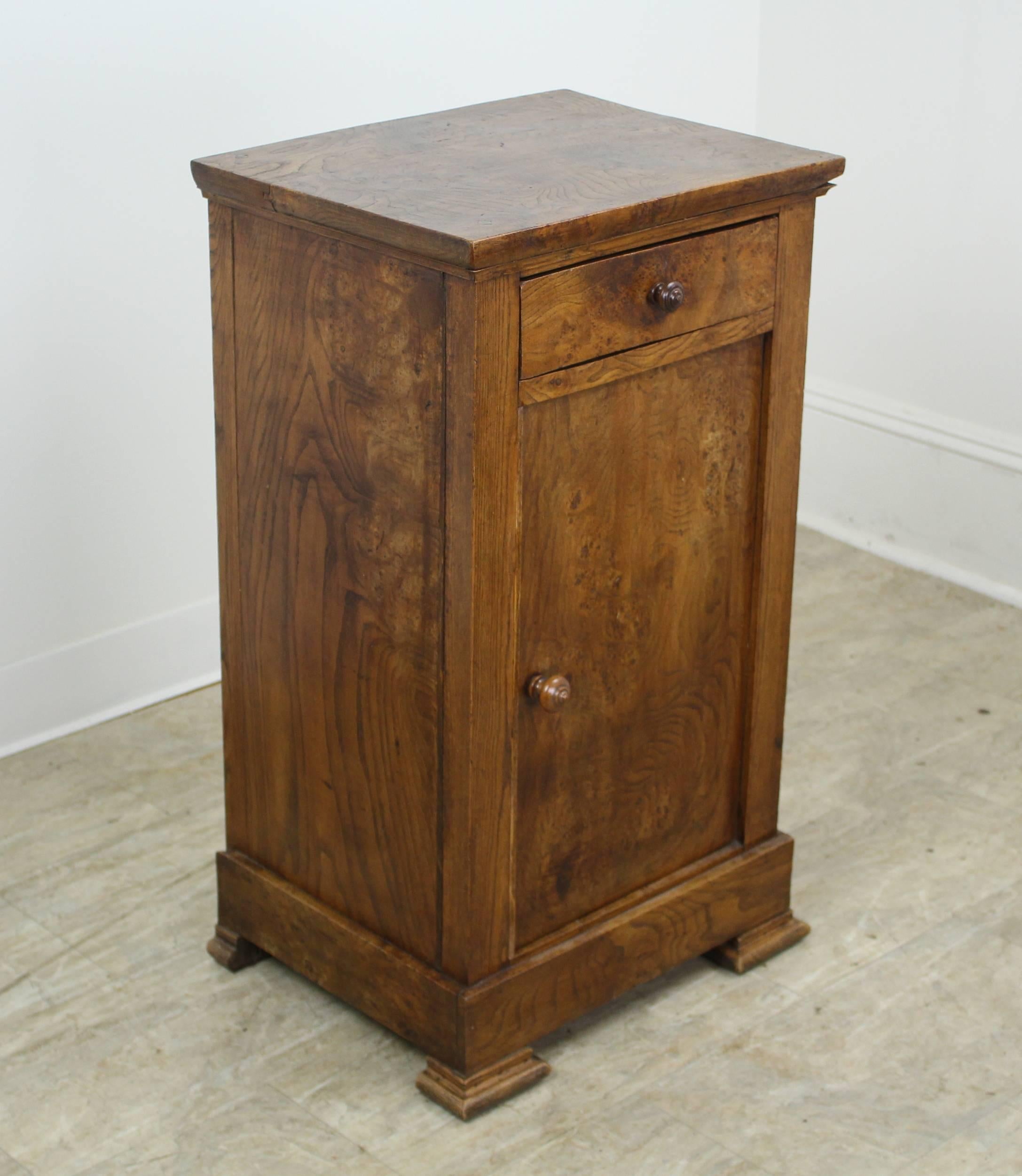 Terrific graining on this burr elm side cabinet, with a nice thick top. Sweet little drawer, and a hand-turned small knob. Lovely classic Louis Philippe feet. Great storage for a practical and handsome nightstand. Correct height for a lamp.