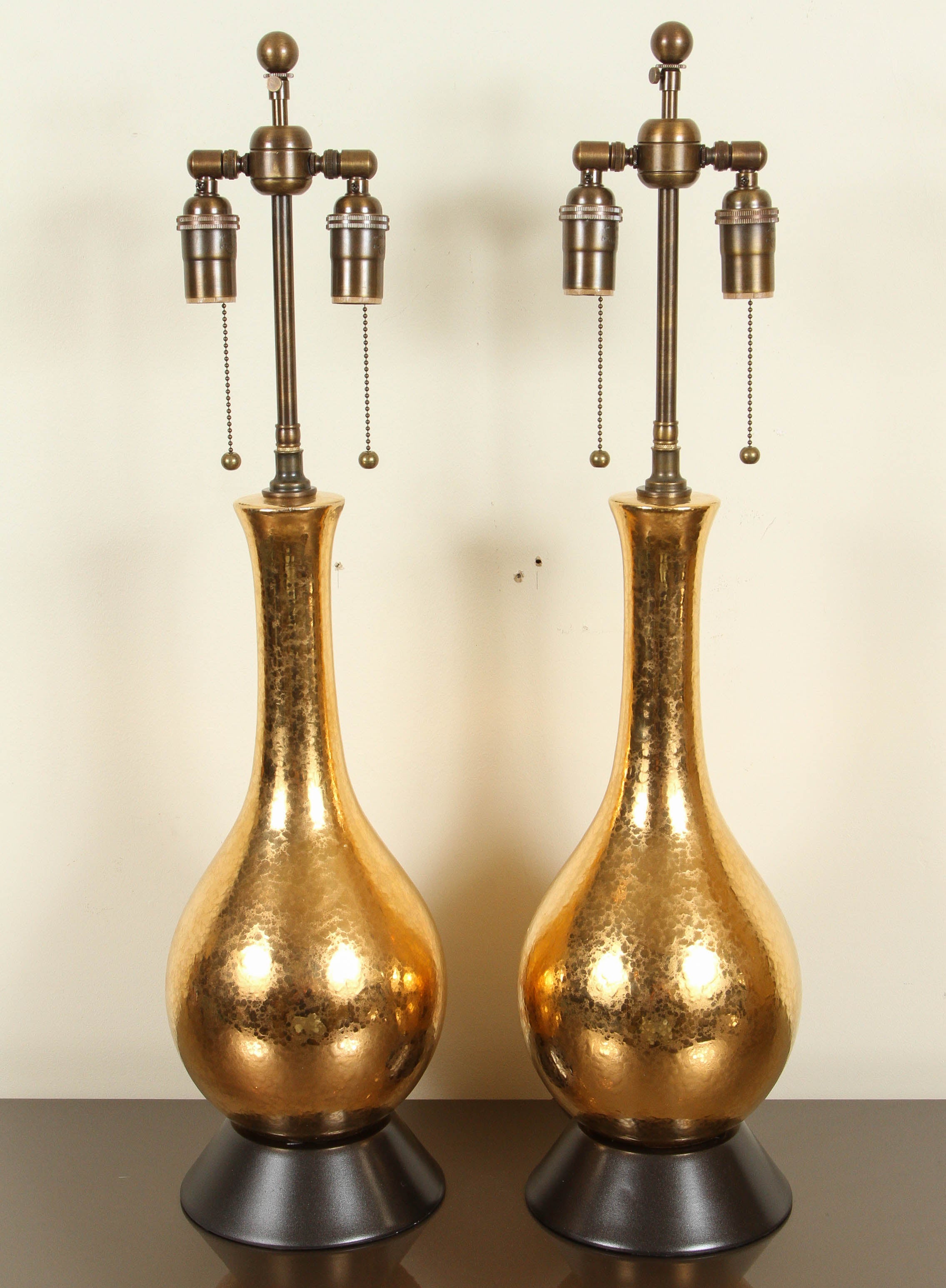 Pair of ceramic table lamps with a beautiful gold crackled glaze finish.
The lamp bodies sit upon bronze finished tapered bases and they have been newly rewired with bronze finished double clusters.