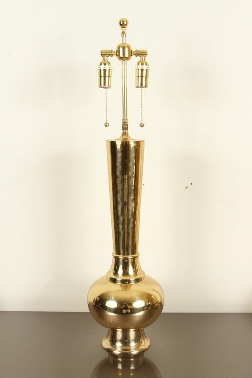 Pair of Elegant polished brass table lamps.
The heavy polished lamp forms have been newly rewired with double clusters.