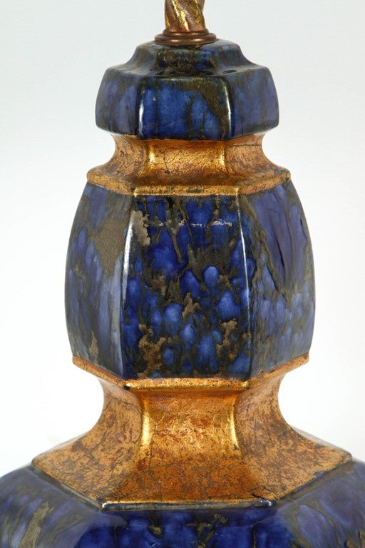 Exquisite pair of large Italian ceramic lamps.
The stunning glazed finish resembles Lapis and is complemented by gilded segments. 
The lamps have been newly rewired with polished brass double clusters.