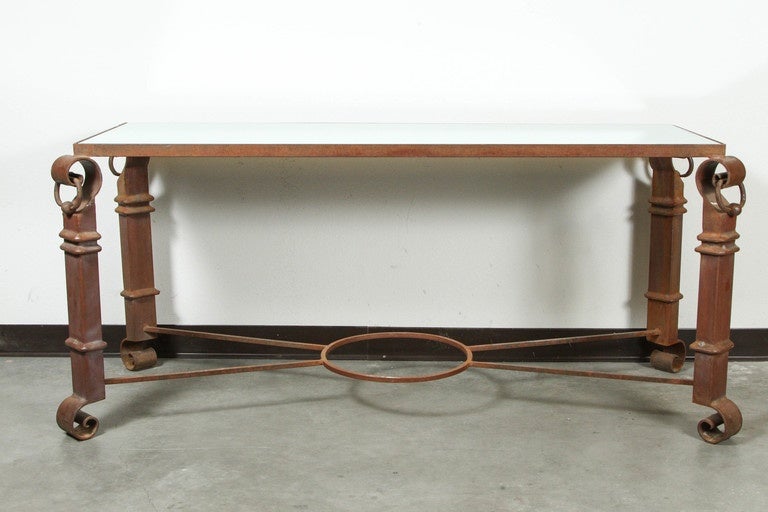 Wrought iron console that has a beautiful rusty weathered patina.
The top of the console is mirrored.