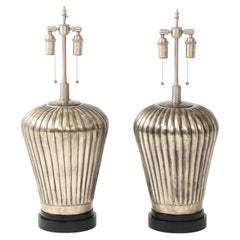 Pair of Large Fluted Metal Lamps with an Antiqued Silvered Finish.