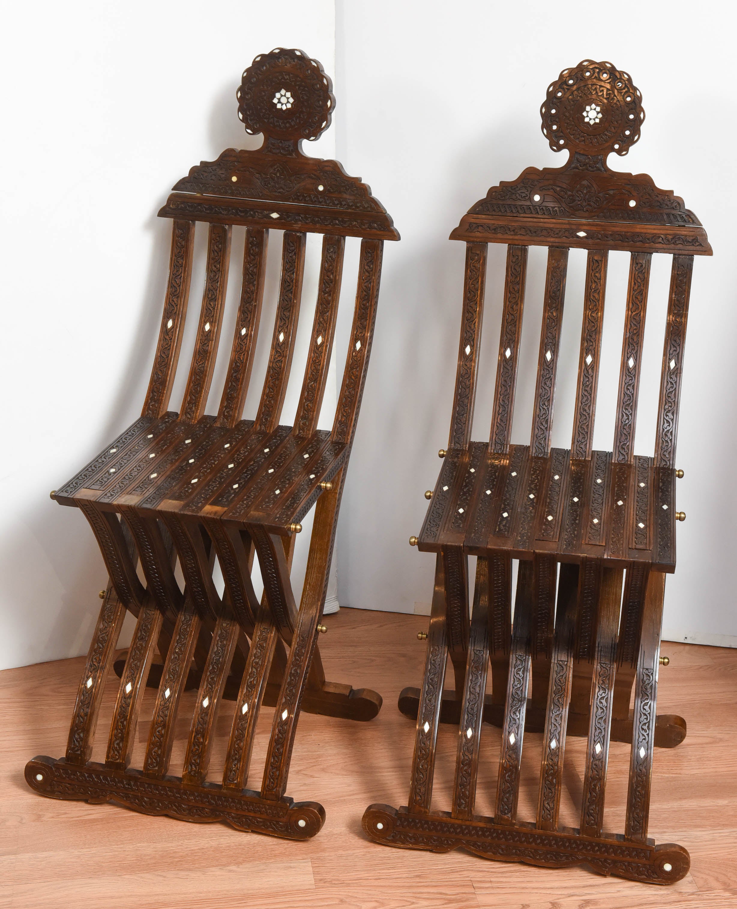 Beautiful pair of folding Syrian scribe chairs with intricate mother-of-pearl inlays.