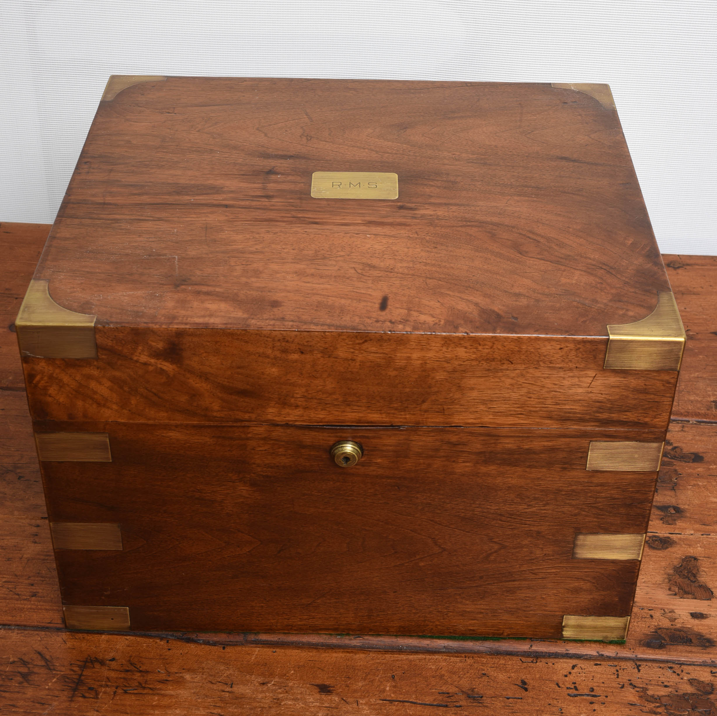 Striking wood box with brass trim and handles.  Lock is inscribed Benson & Hedges London.  Probably used a humidor.