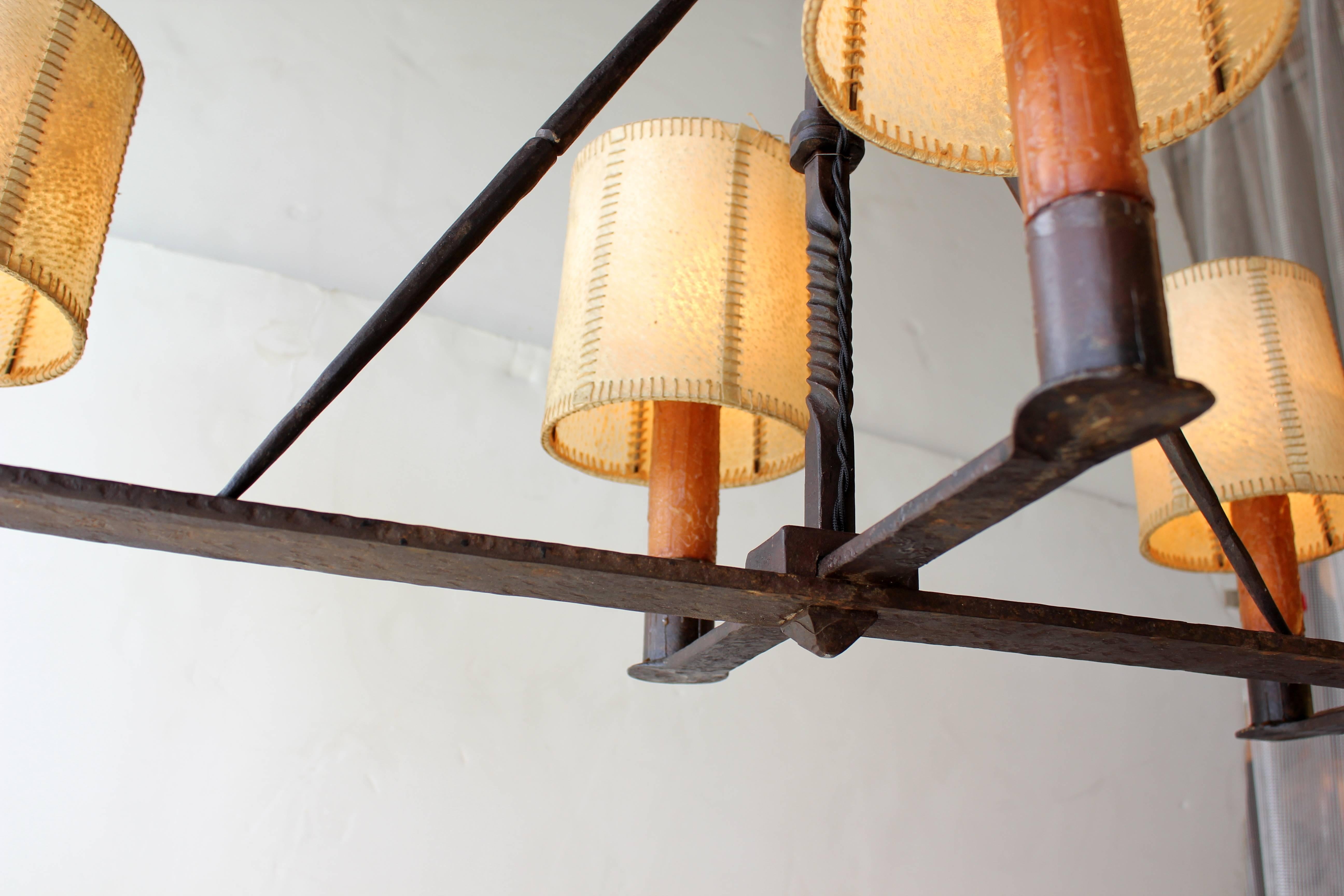 Early 20th century Spanish wrought iron chandelier with original parchment shades.