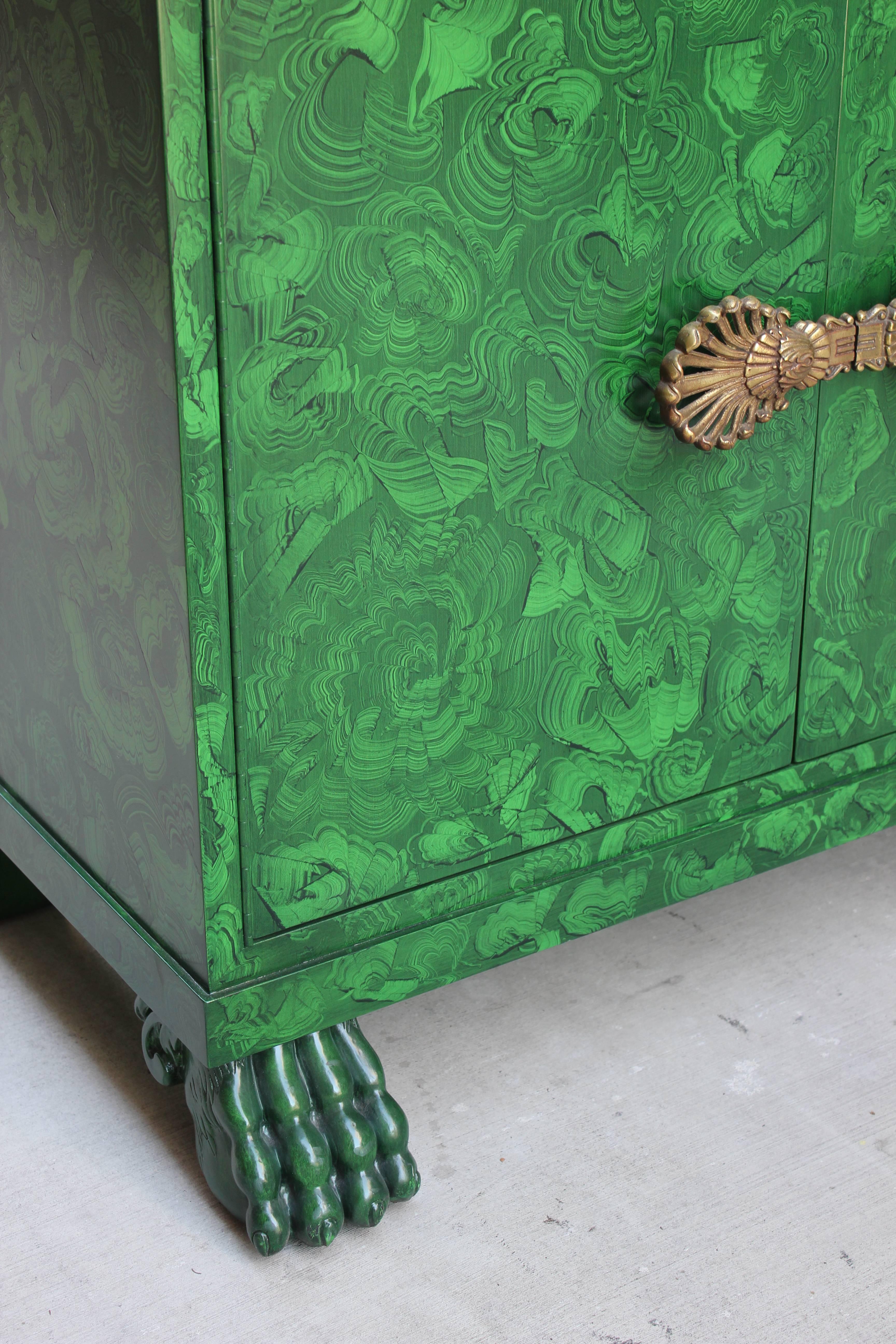 Faux malachite lacquer cabinet with lion paw feet.