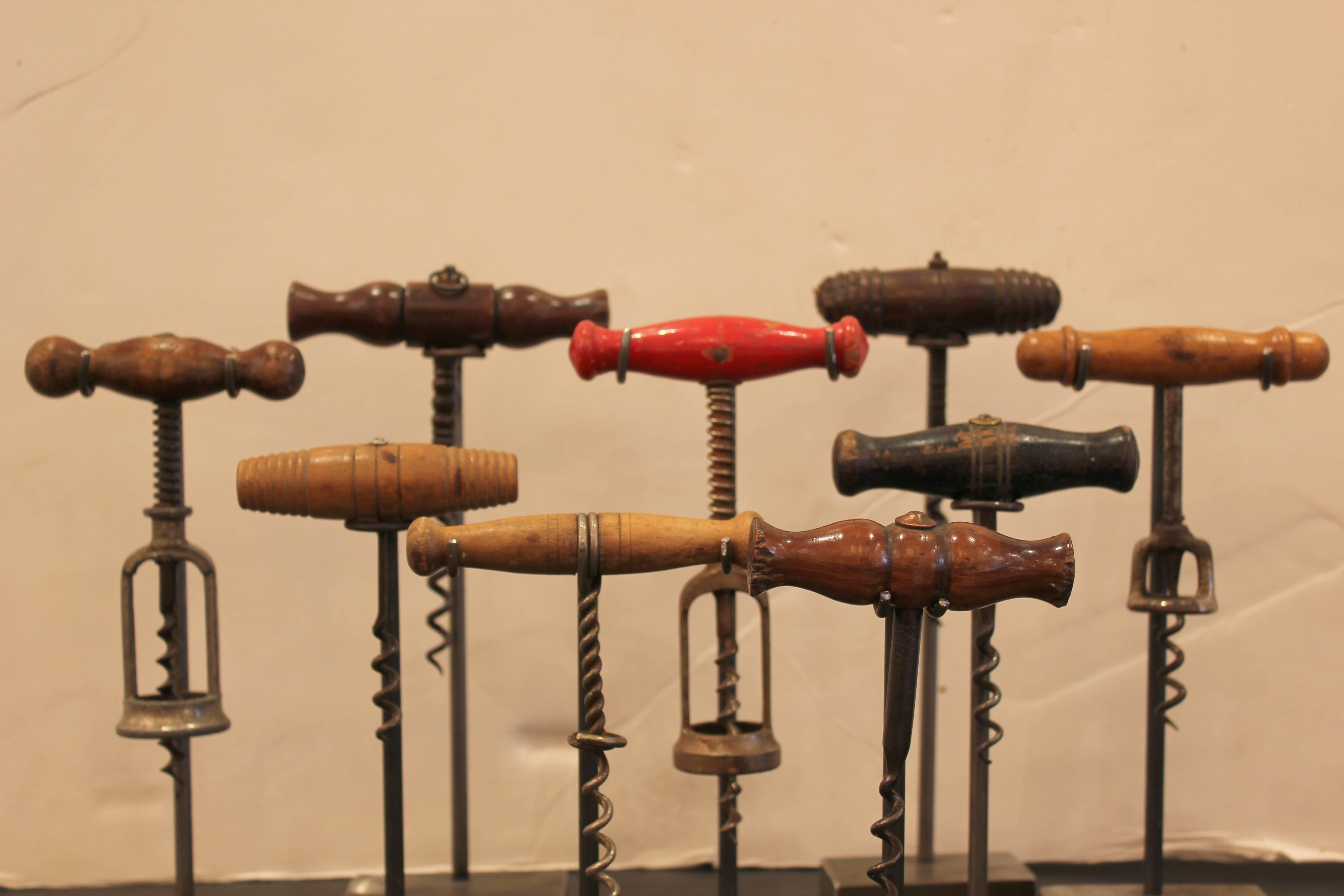 A collection of French corkscrews on stands, 
20th century.
 