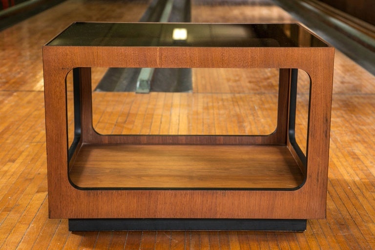 Pair of side tables with smoked glass tops with cut-out wood sides.