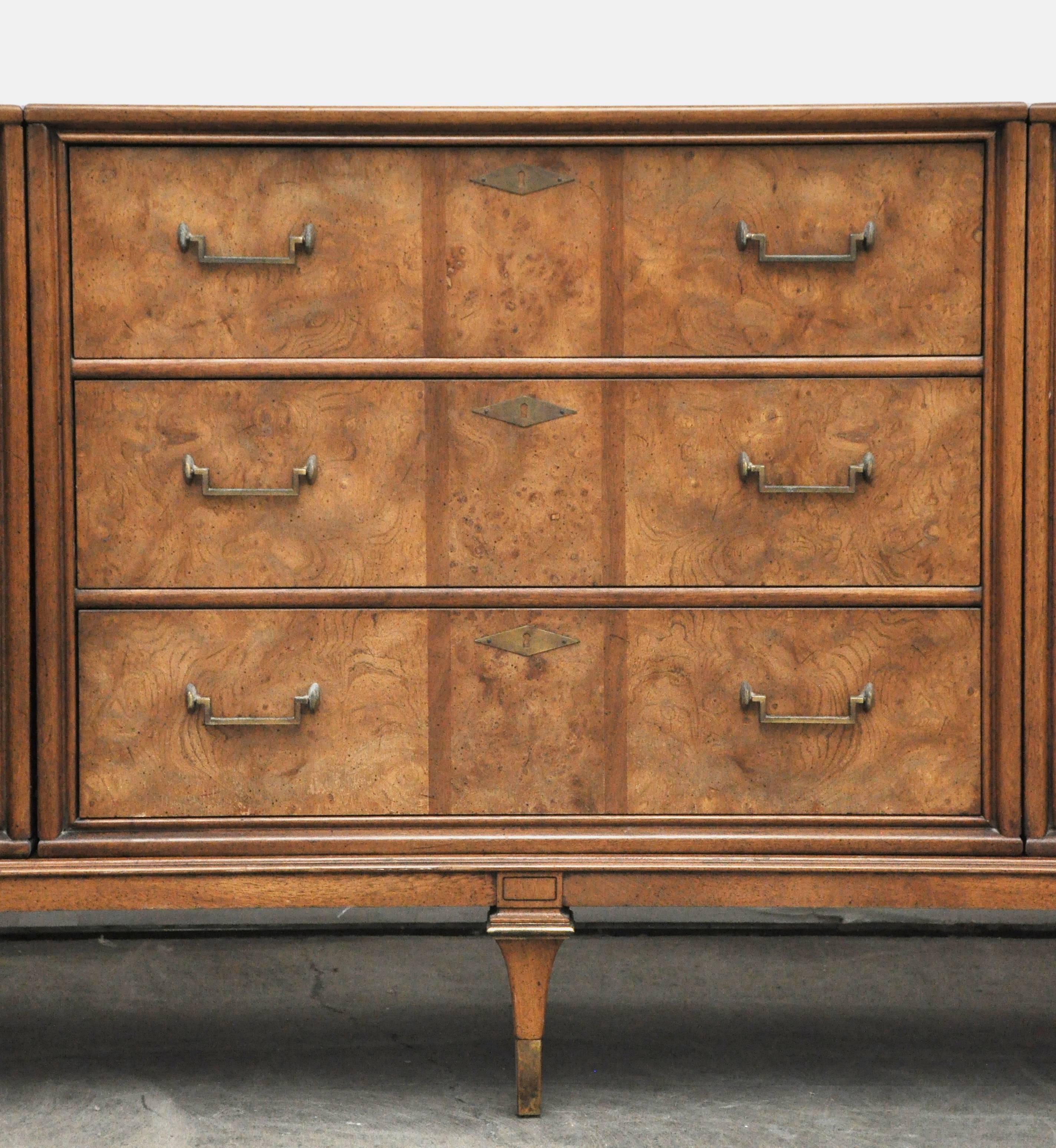 Fine quality Hollywood Regency style Bernhard Rohne for Mastercraft brass and burled wood credenza. Three cabinet pieces on a single plinth base. Beautiful finished back. Total of 11 drawers. Signed Mastercraft.