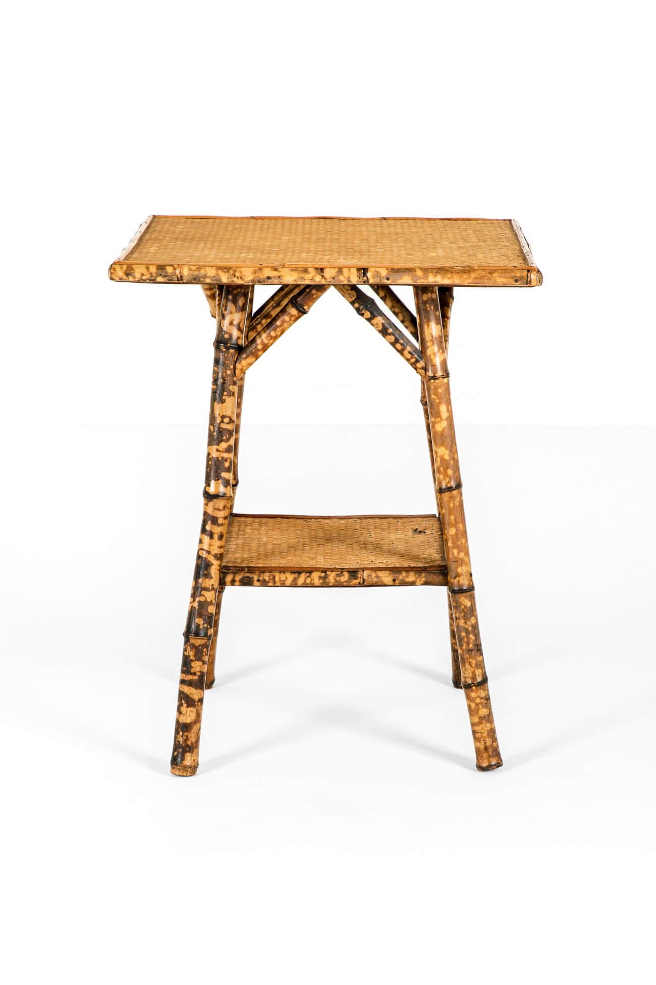 A late 19th century tiger bamboo side table with two woven tiers on splayed legs and triangular supports.

A characterful and versatile table in good condition with excellent colour and patina.

English, circa 1895.

TOTAL

W: 52 CM  W: 20.4