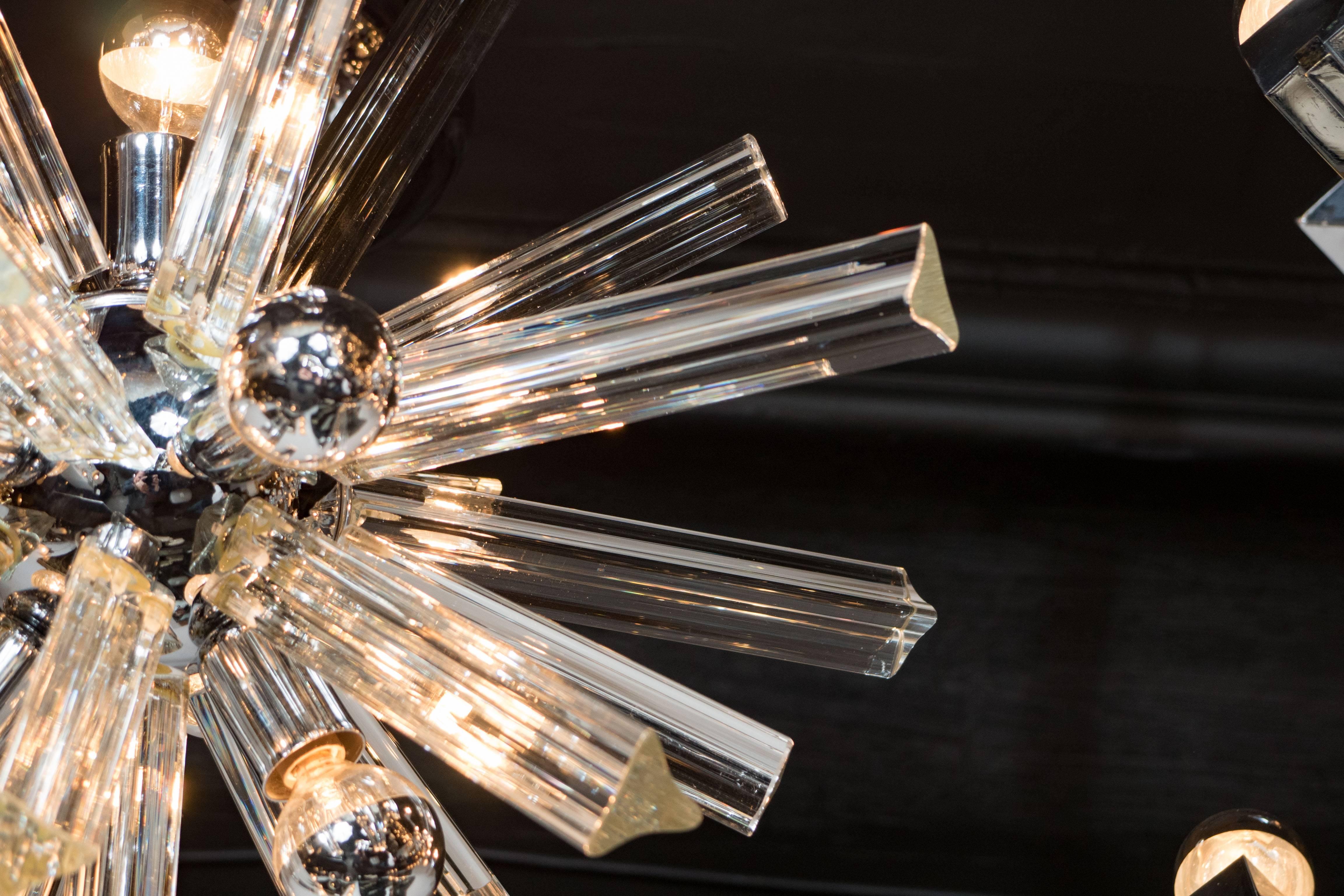 This stunning and graphic Mid-Century Modern Sputnik chrome chandelier was realized in Murano, Italy- the island off the coast of Venice renowned for centuries for its superlative glass production- circa 1970 by esteemed lighting atelier Camer.