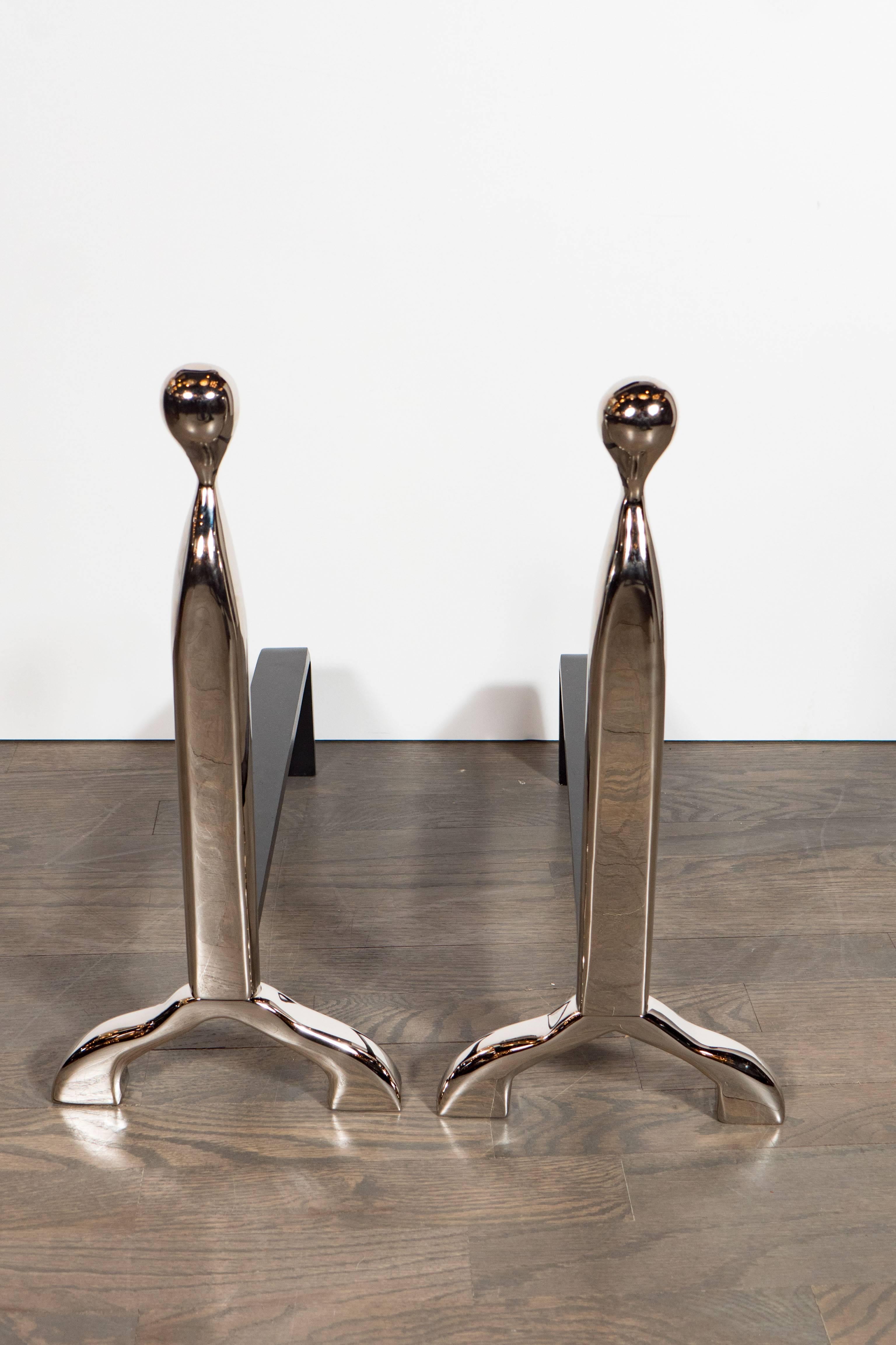 These stunning custom Mid-Century Modernist style andirons feature an elegant hair-pin design shown in polished nickel with a black enameled stem. They can be ordered in a variety of finishes. We also have an extensive custom range of fire tools,
