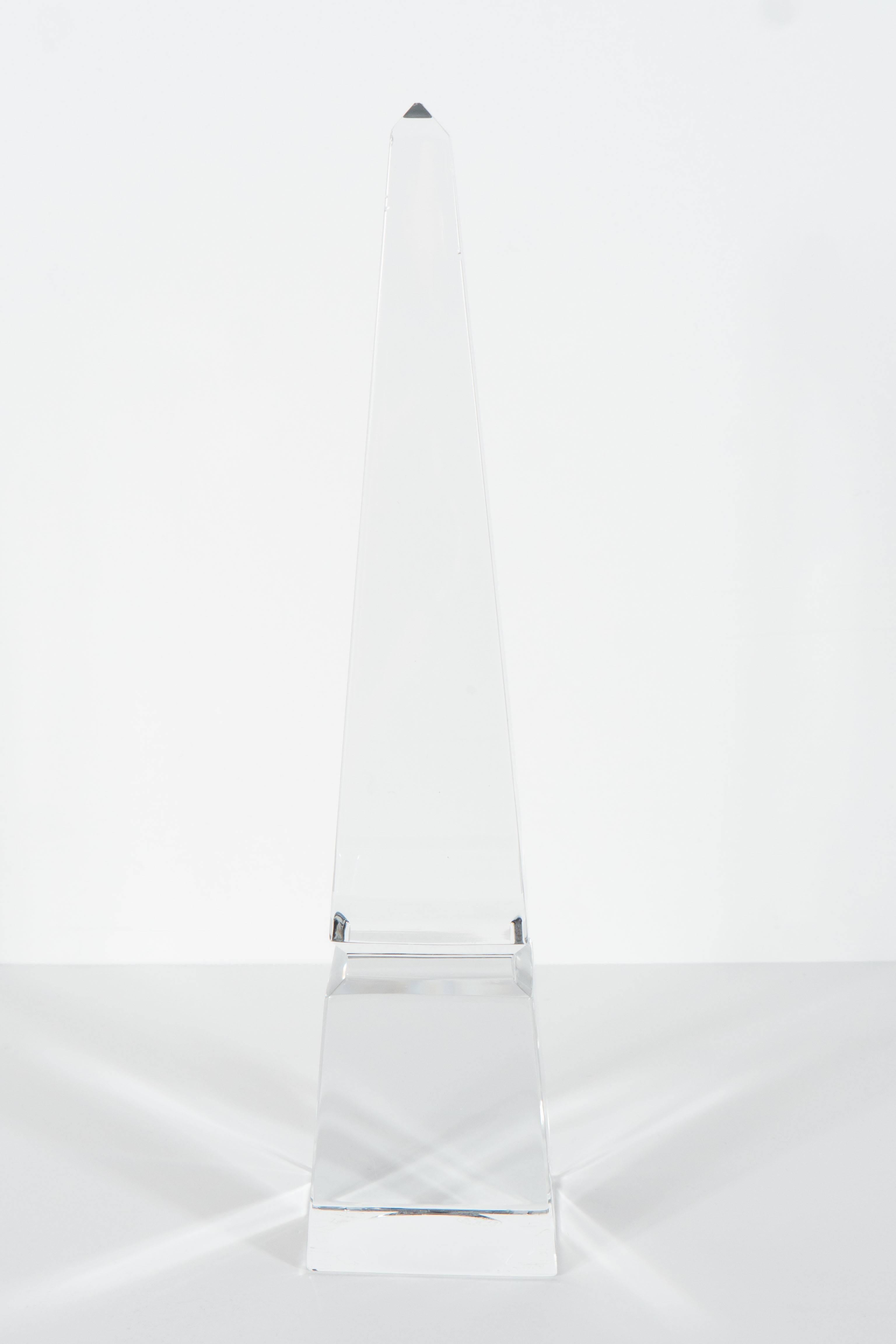 A modernist crystal obelisk by Baccarat with faceted detailing. It bears the Baccarat stamp and seal on the bottom. Excellent condition.