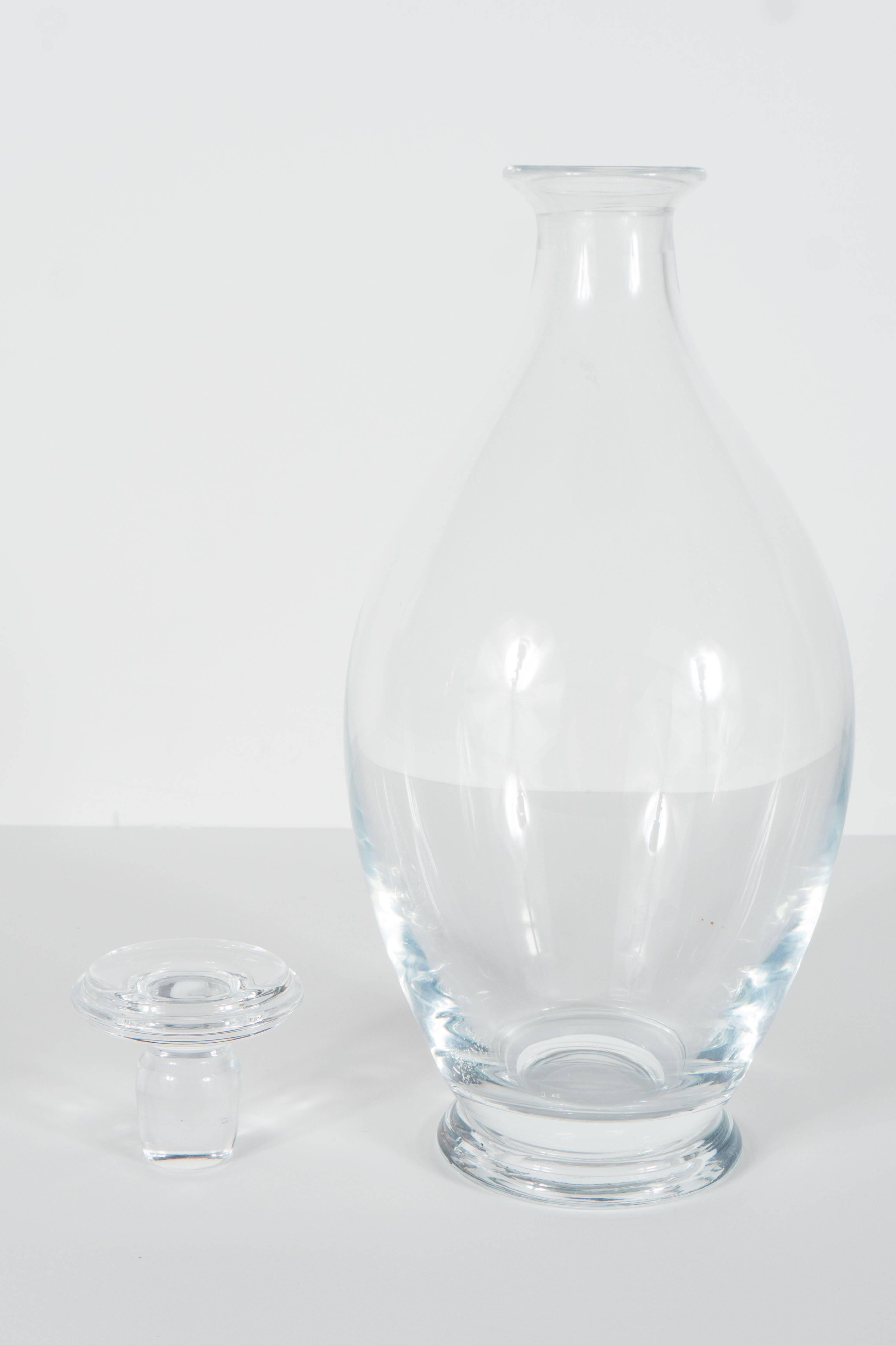 This very elegant decanter features a skyscraper style stepped base and stopper with a flared conical design body and spout. This bears the mark Tiffany & Co on the bottom. A great bar accessory, object or beautiful on a table for use. It is in