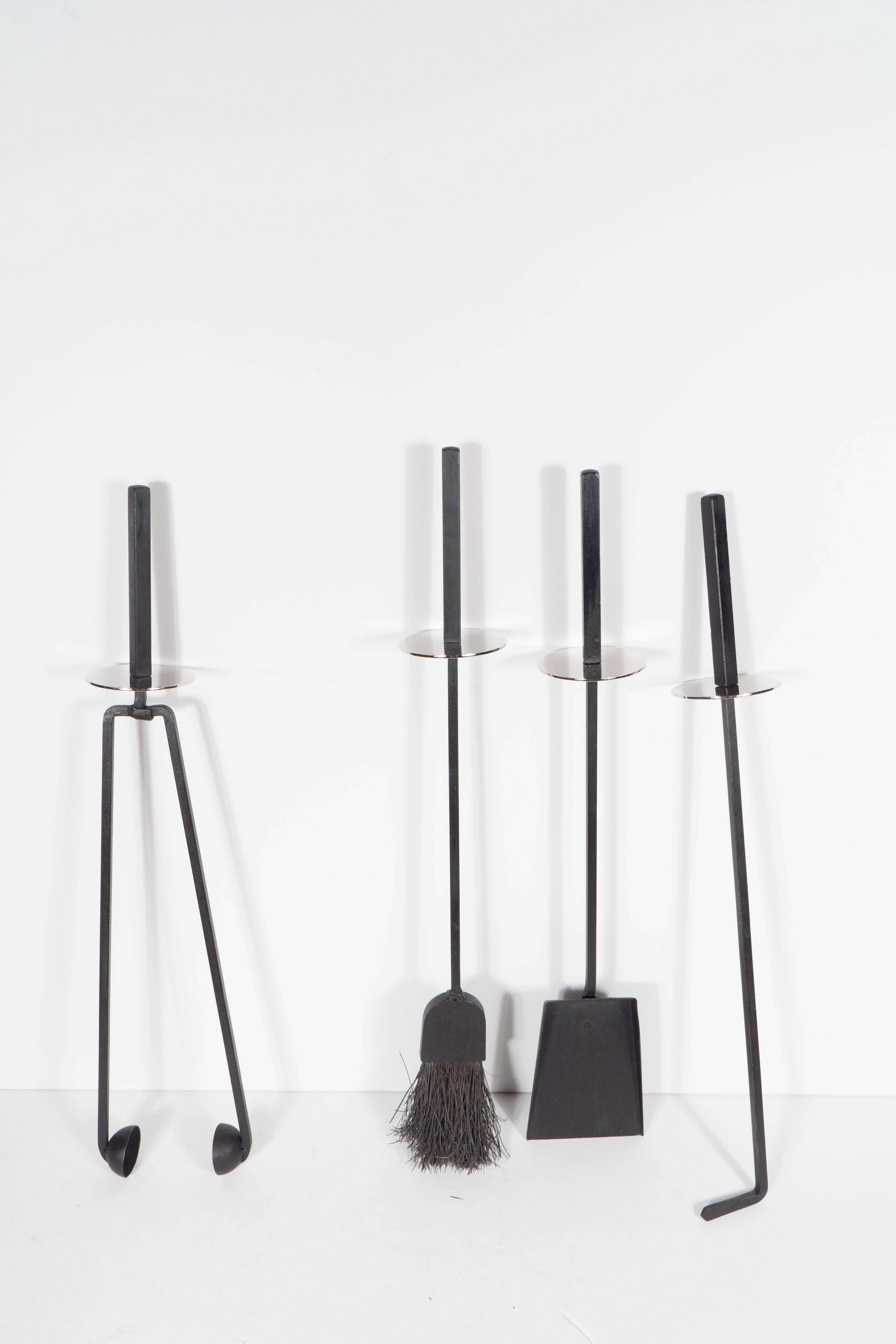 This very sophisticated firetool set features a matte black enamel finish. Designed by Mel Bogart by Stewart-Winthrop. The base is circular with a square column form stem supporting four fire tools consisting of a poker, log holder, broom and shovel