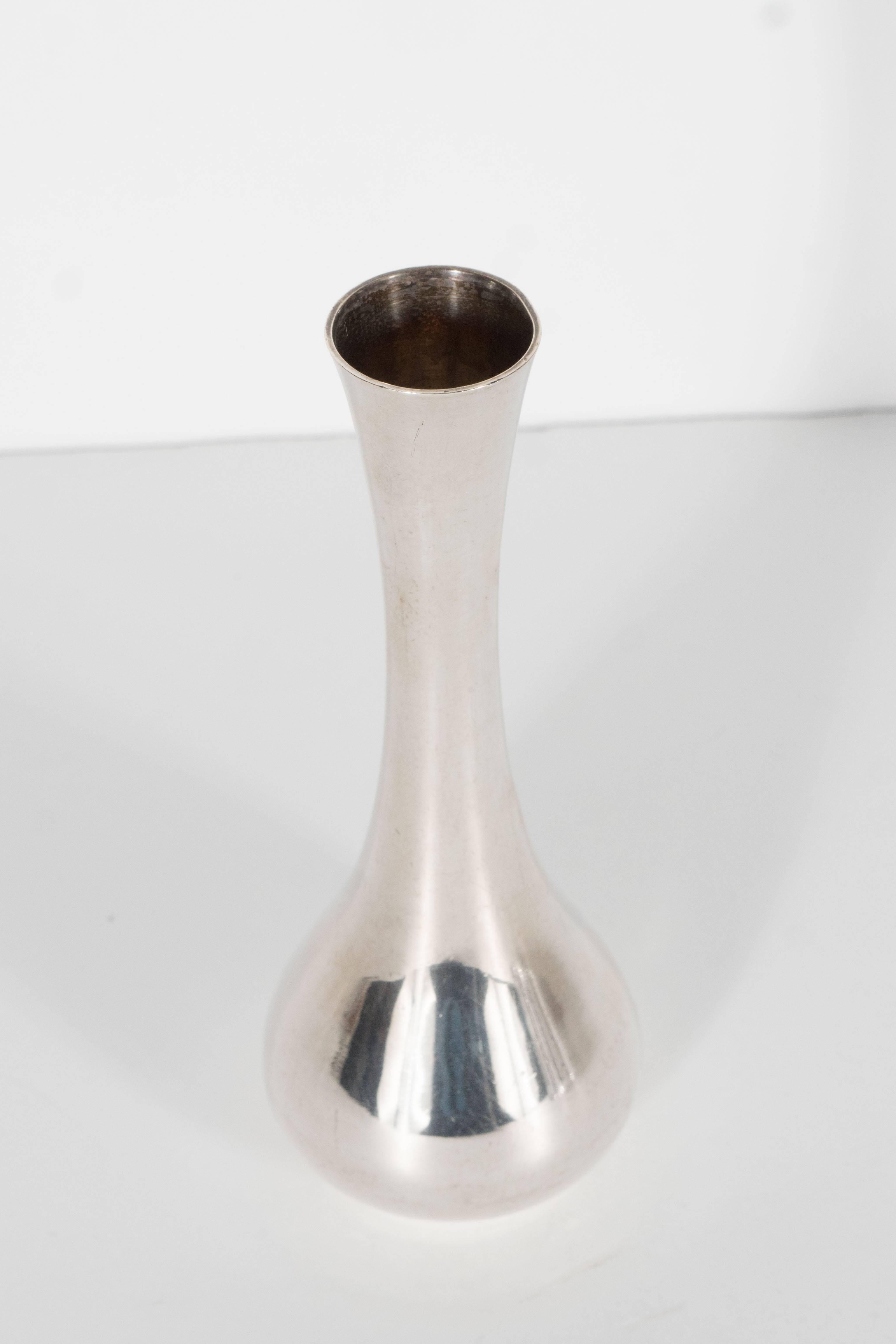 This stunning sterling silver bud vase has a nice heavy weight and features a clean stylized hour glass form design. It would be a great accent piece and also functional as a bud vase it bears the Tiffany sterling mark on the bottom.