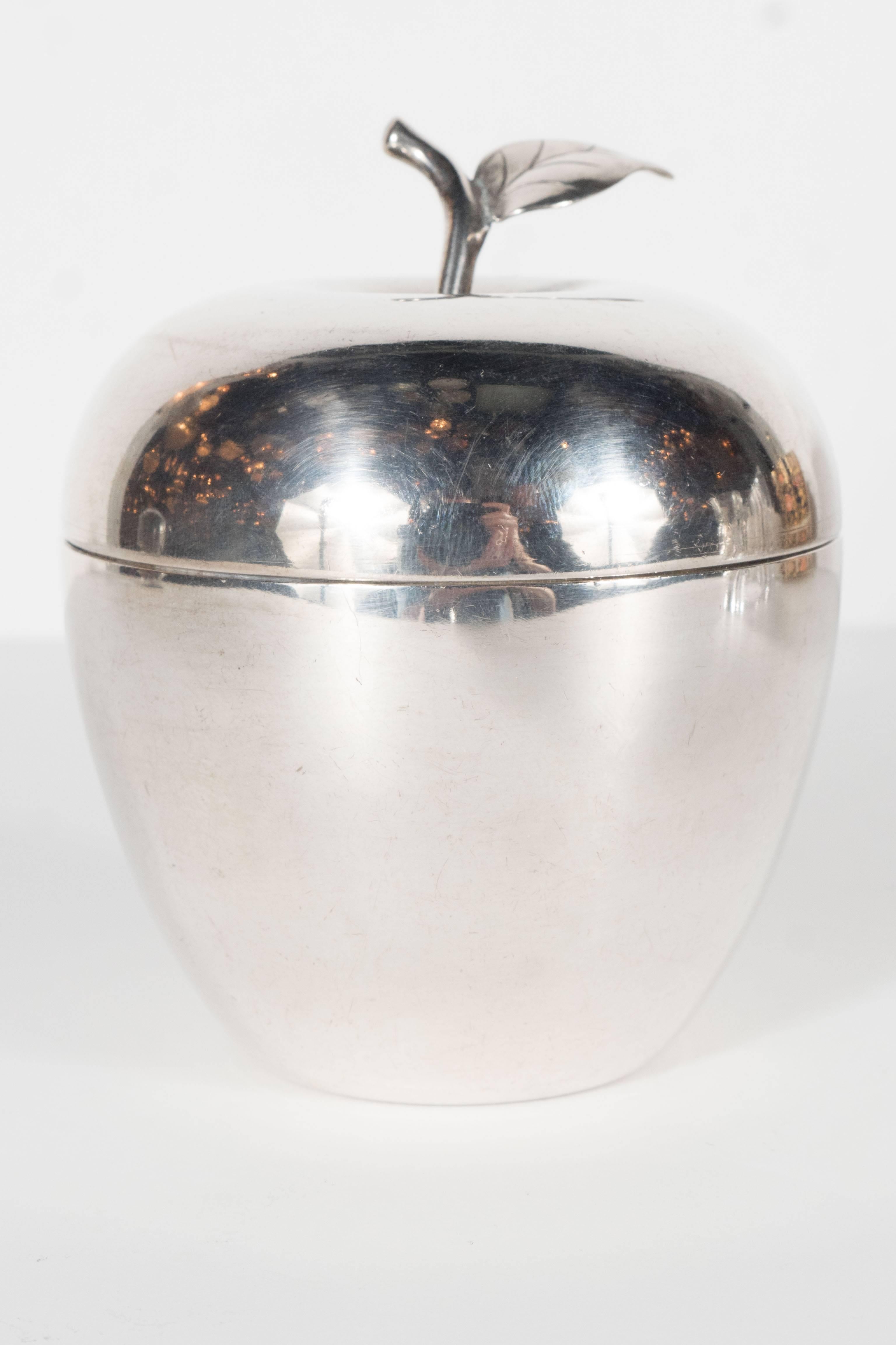A stunning figural box by Tiffany & Co., this large apple shape box is beautifully rendered in sterling silver and is complete with stem and leaf.
Hallmarks: Stamped on the underside Tiffany & Co Makers, Sterling, 23748, 88.
Weight: A sturdy piece