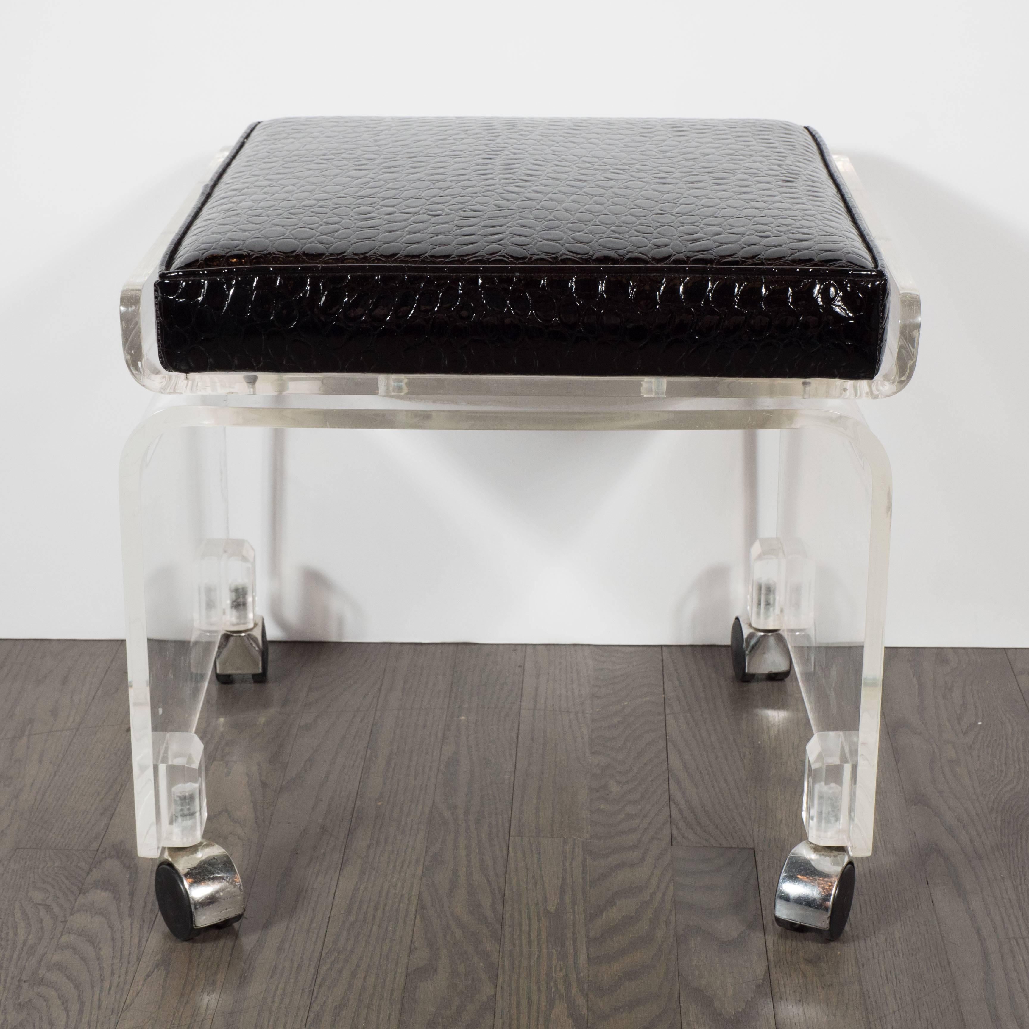 A Mid-Century Lucite swivel chair in newly upholstered faux crocodile fabric. A waterfall design is a single piece of curved Lucite is mounted on chrome-covered casters. A swivel mechanism connects the seat, which itself has a wraparound curved