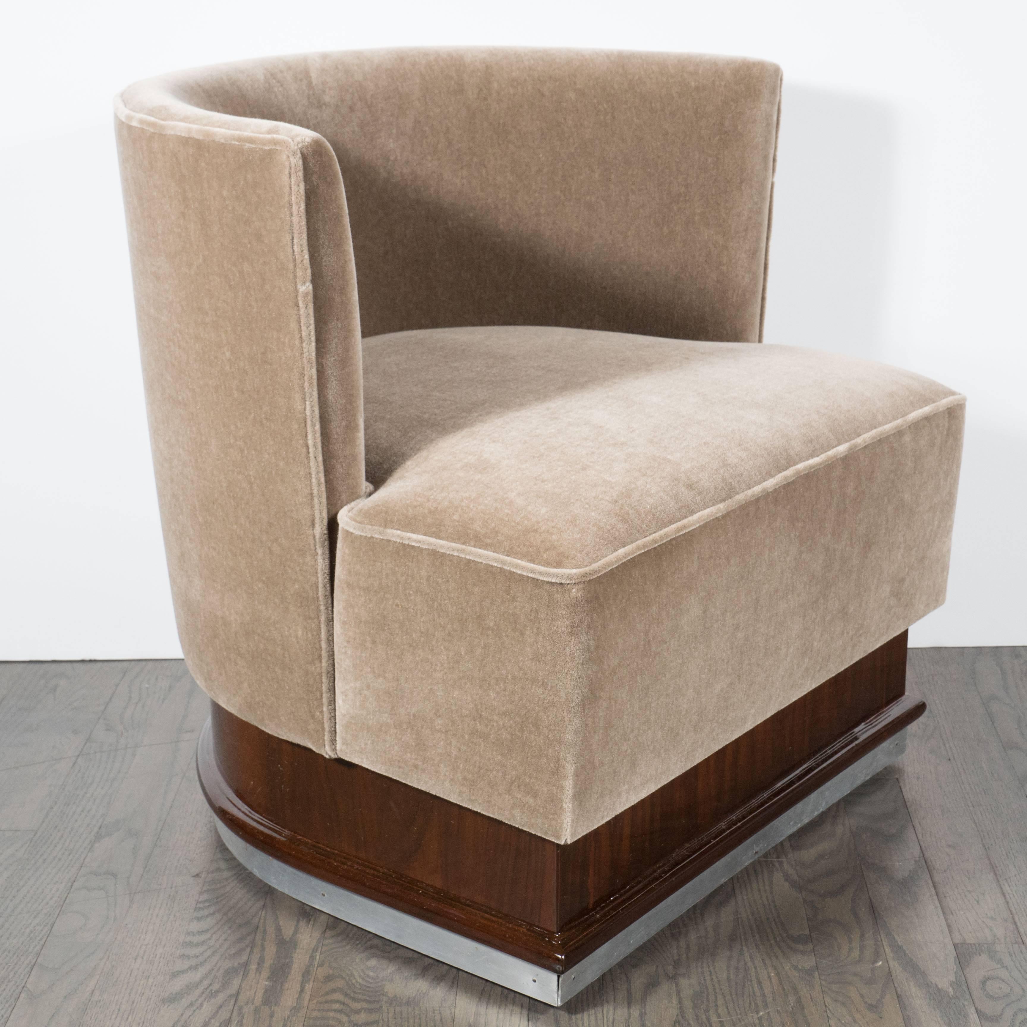An Art Deco Machine Age curved-back chair and ottoman, attributed to the legendary Austrian-American Art Deco designer Paul Frankl. Frankl's sophisticated yet causal aesthetic attracted the Hollywood elite of the period, garnering clients that
