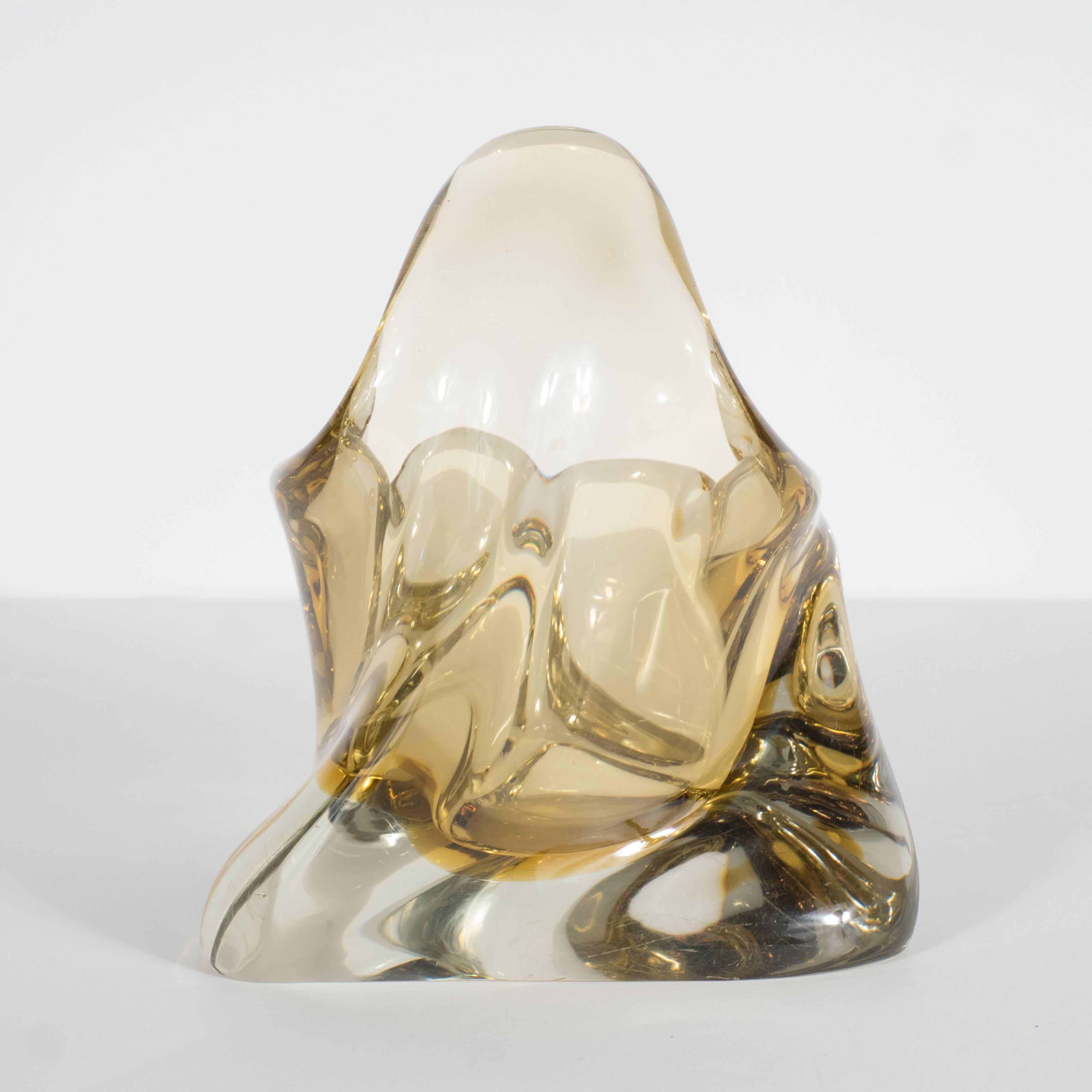 A Mid-Century canary yellow 'splash' handblown Murano glass ashtray. A three-sided curved base supports a spiraling form with two cigarette supports and a curved glass fold. A beautiful piece on its own as an objet for a shelf, console or tabletop.