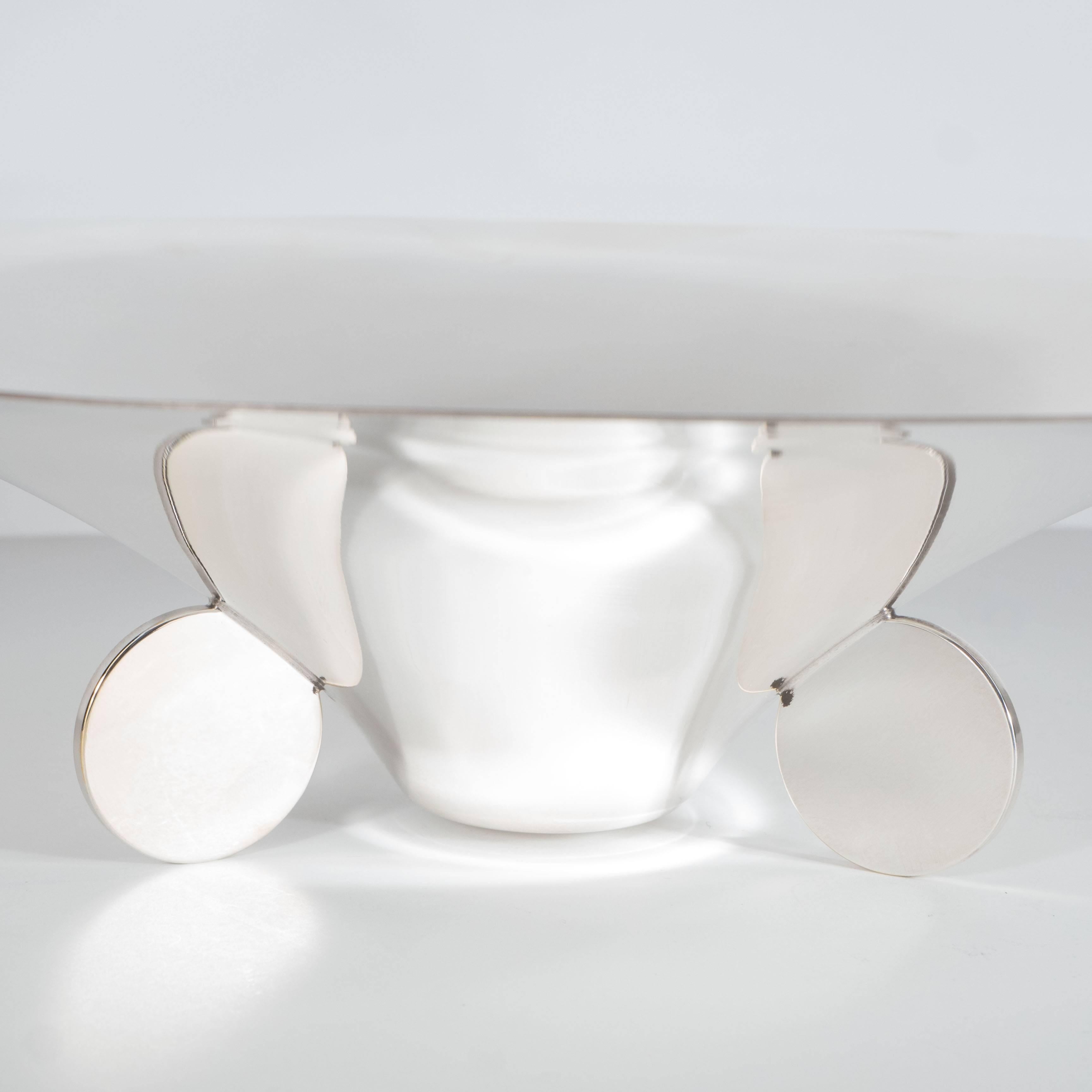 This elegant Art Deco silver plate bowl or dish was realized by the fabled design firm Ikora in Germany circa 1930. It offers a sculptural concave form funnel-shaped dish with a flat bottom is adorned by a trio of flat circular support disks. This