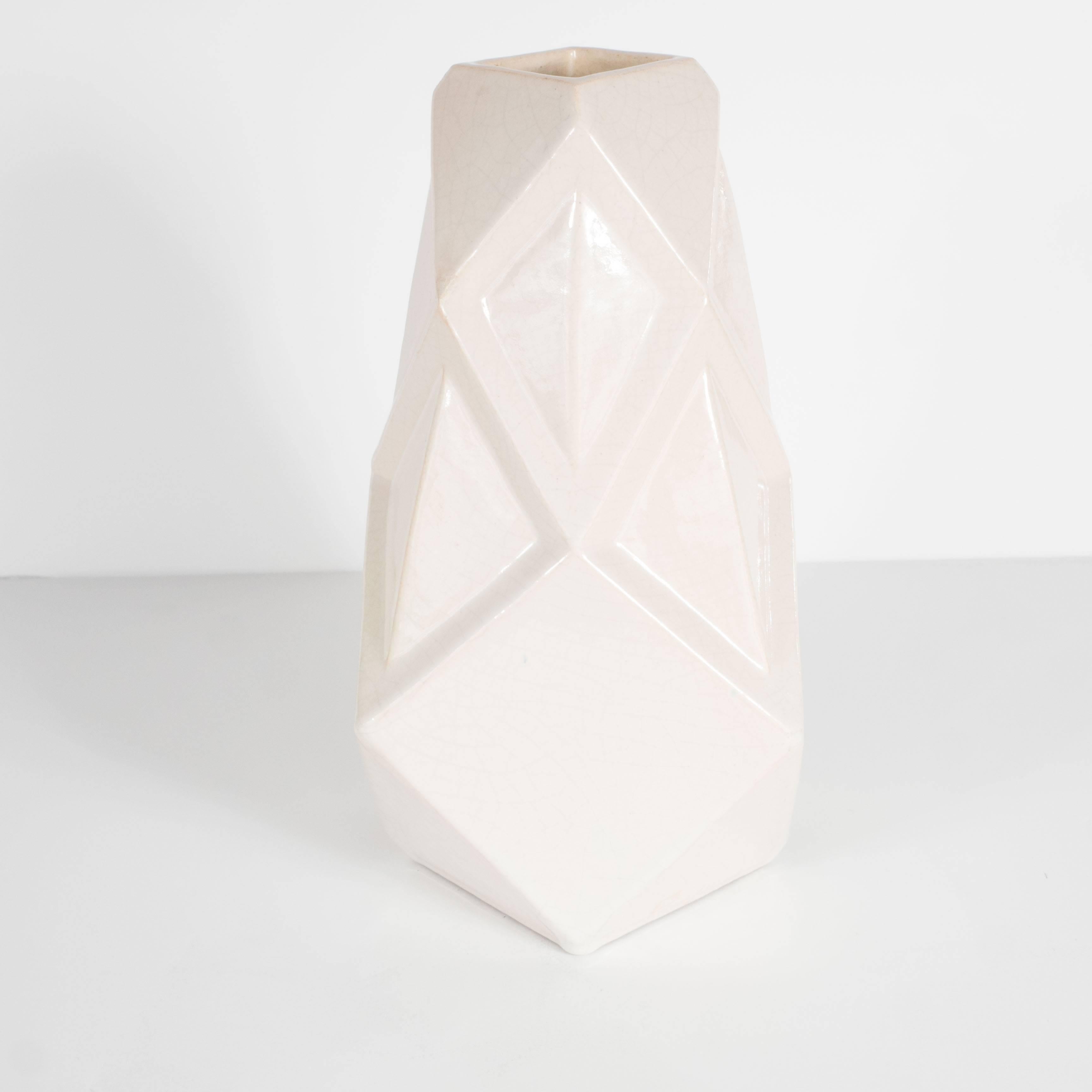 This perfect vase features a cubist relief geometric design in a crème crackle glaze finish. A wonderful decorative as well as functional object, great in a bookcase or as a stand alone on a table. It bears the mark made in France Boulogne.